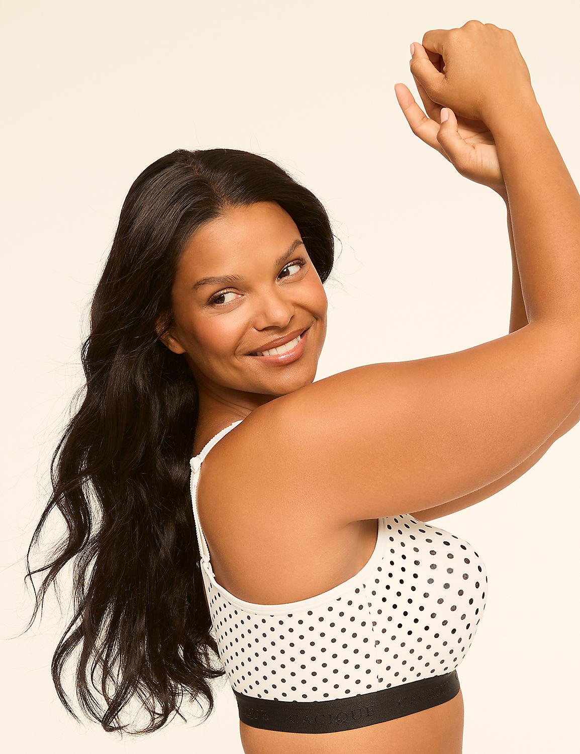 A smiling woman with long dark hair poses with her arms raised against a plain, light background. Product Image 3