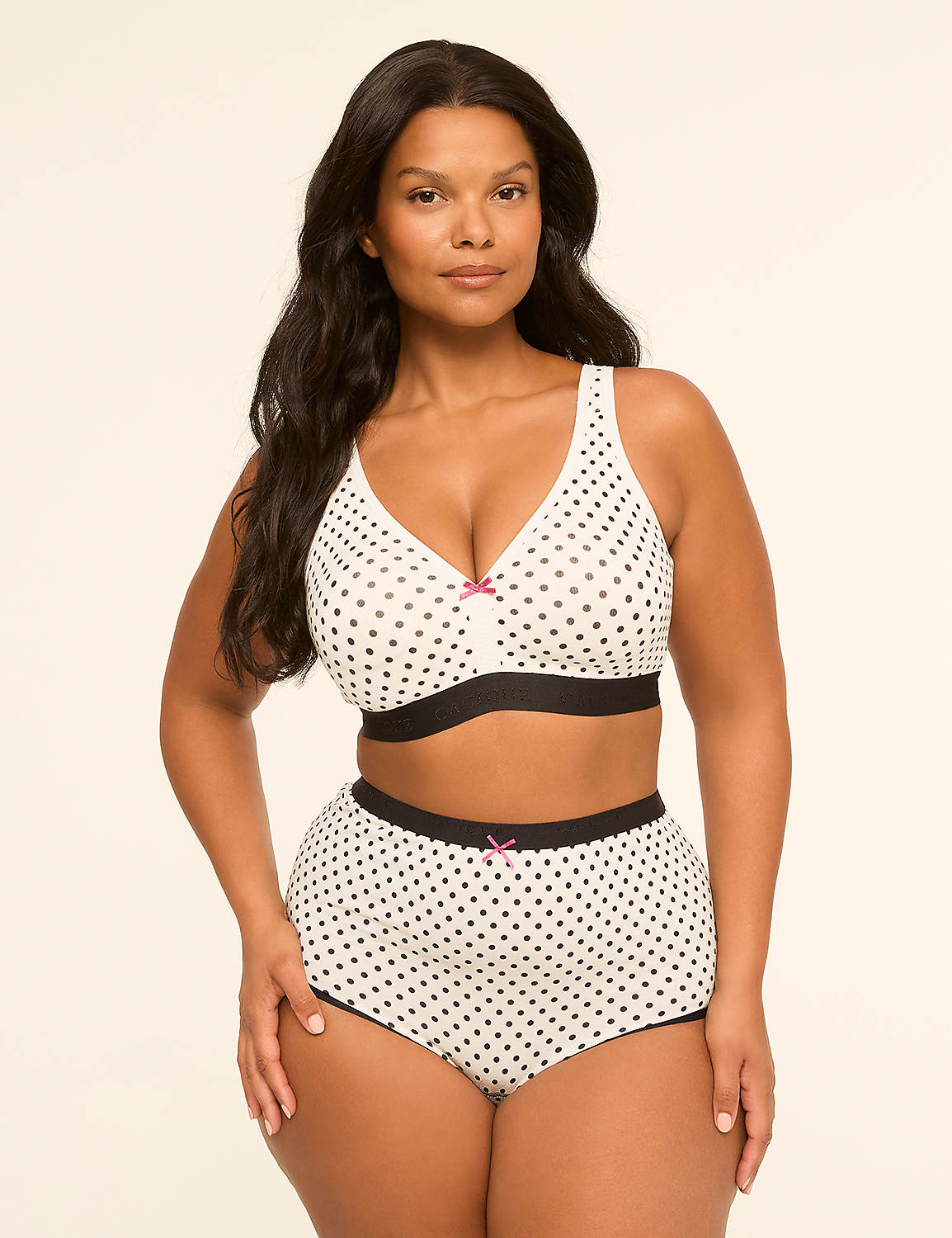 A woman with dark hair and a polka dot bra and shorts stands against a plain, light-colored background. Product Image 4