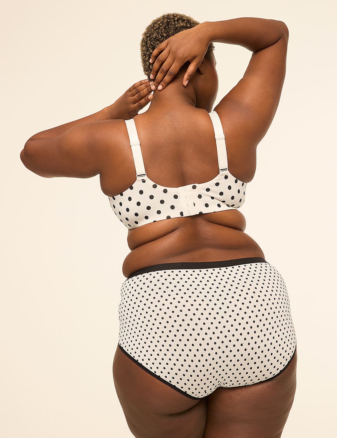 A woman with dark skin and short, curly hair is shown from behind, wearing a white polka-dot bra and matching underwear against a plain, light background. Product Image 2