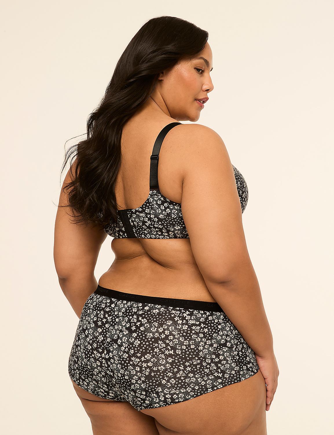 A woman in a floral bra and shorts stands against a plain, light-colored background. Product Image 2