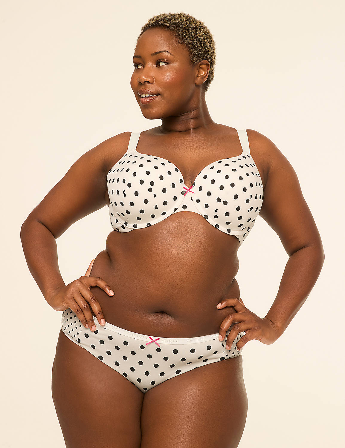 A woman in a polka dot bra and underwear stands with her hands on her hips against a plain, light background. Product Image 4