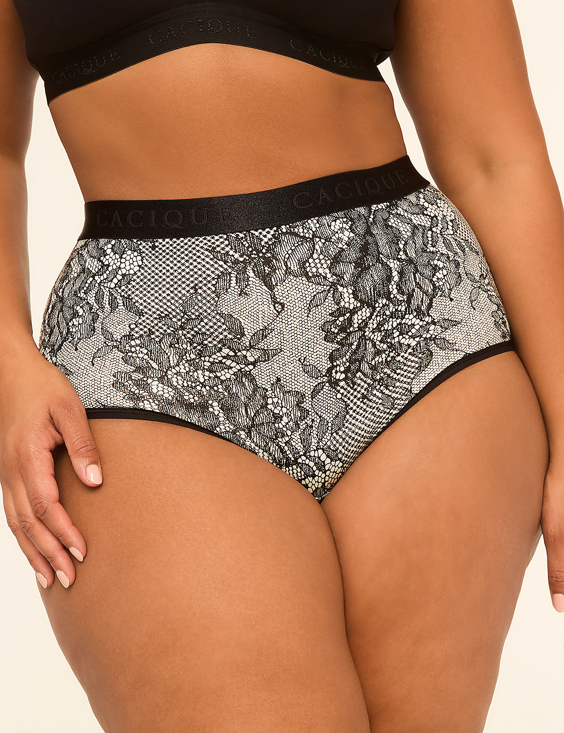 A woman's torso is shown from the waist down, wearing high-waisted lace panties with a floral pattern, against a plain, light-colored background. Product Image 1
