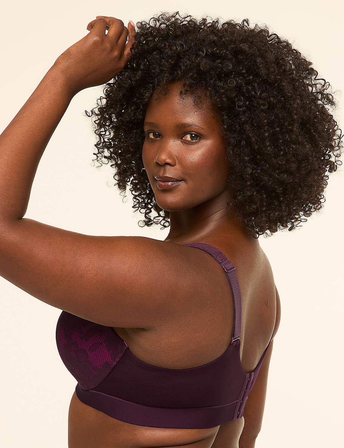 A woman with dark, curly hair poses in a purple bra against a plain, light background. Product Image 3