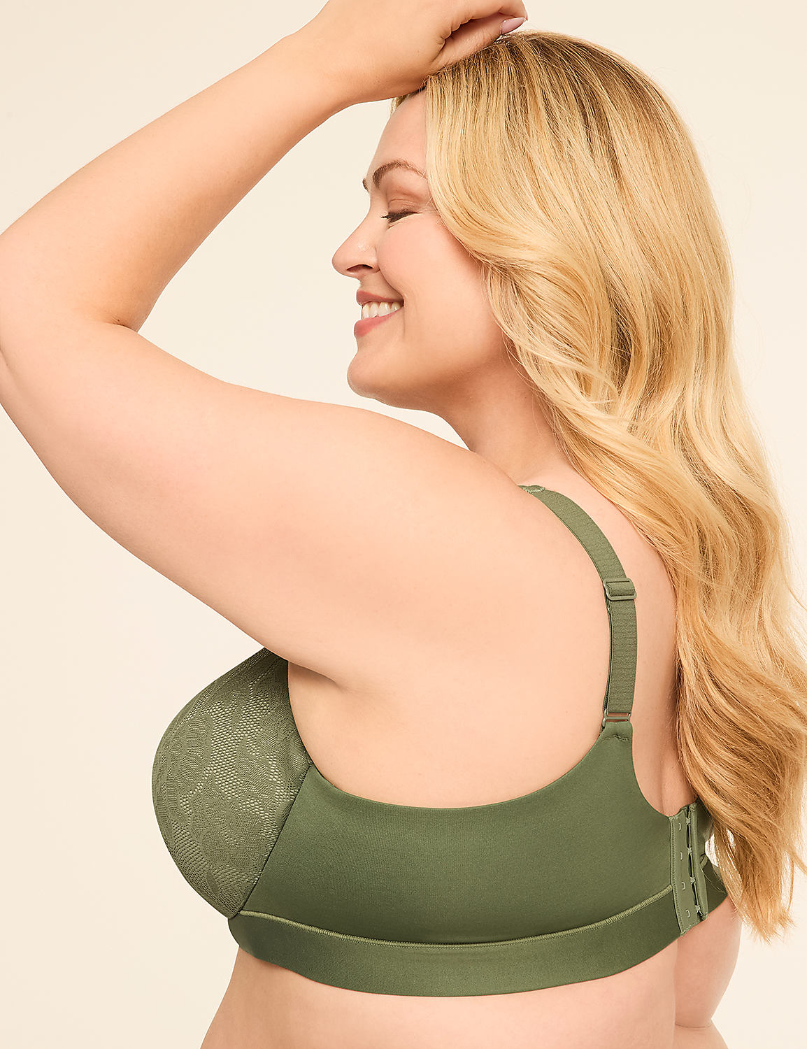 A woman with blonde hair smiles as she poses in a green bra against a plain, light background. Product Image 3