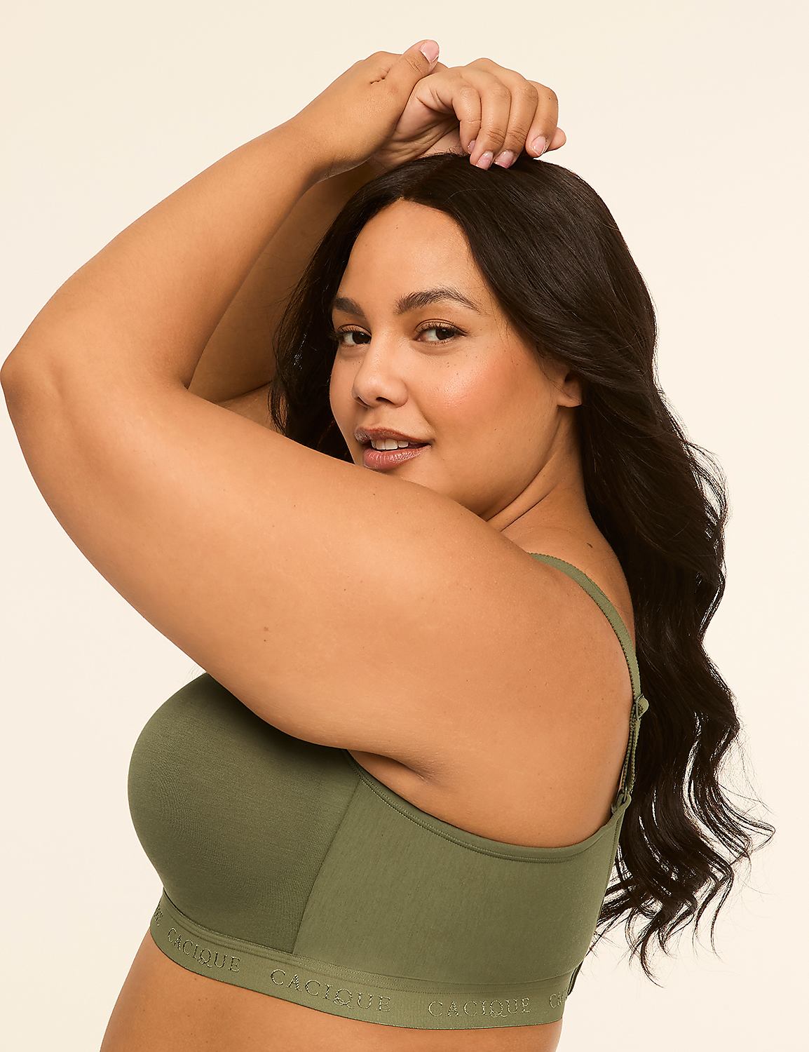 A woman in a green bra poses with her arms behind her head against a plain, light background. Product Image 3
