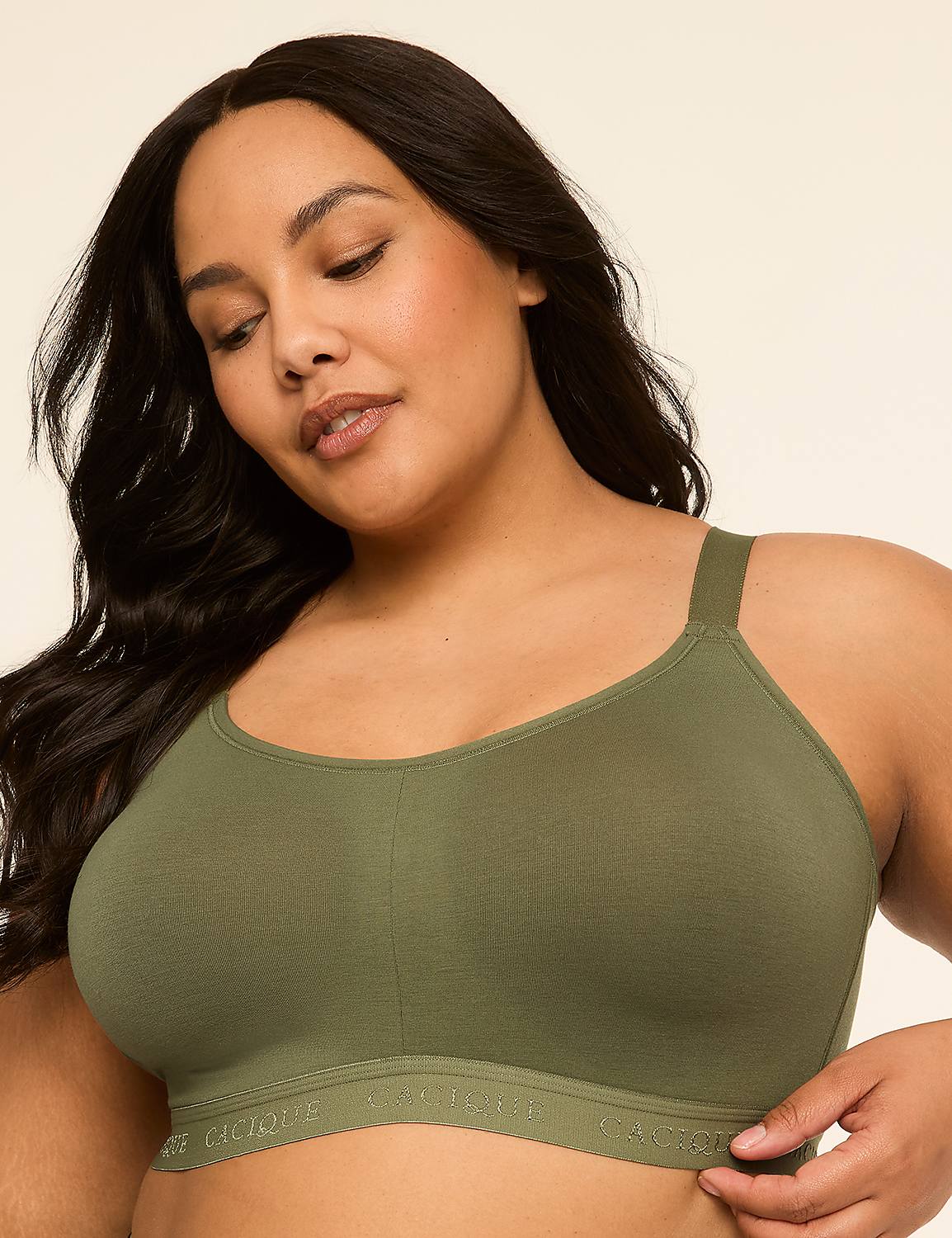 A woman with dark hair wears a green bra against a plain, light background. Product Image 1