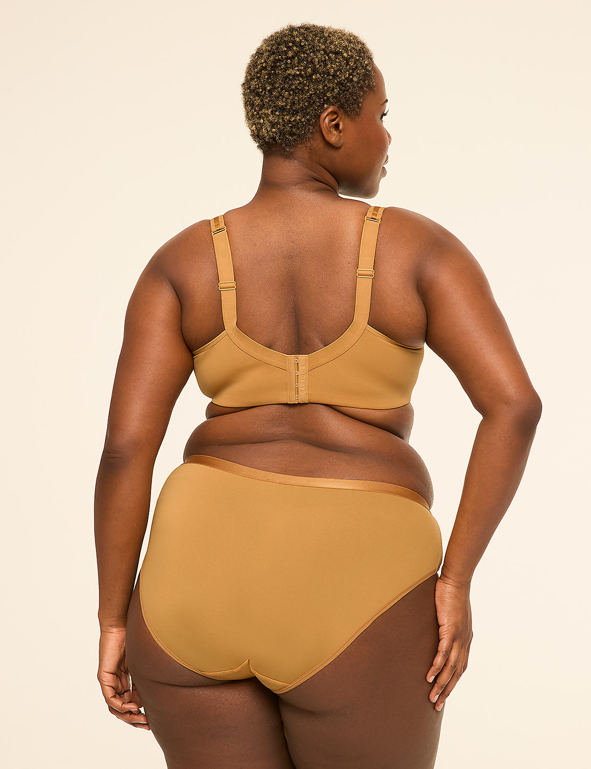 A woman in tan lingerie stands with her back to the viewer against a plain, light-colored background. Product Image 2