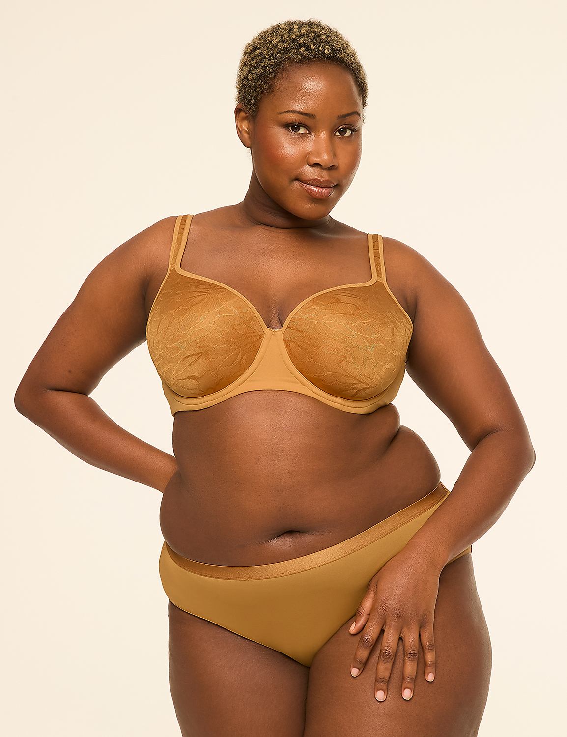 A woman with short, blonde hair and dark skin poses in a tan bra and matching underwear against a plain, light-colored background. Product Image 4