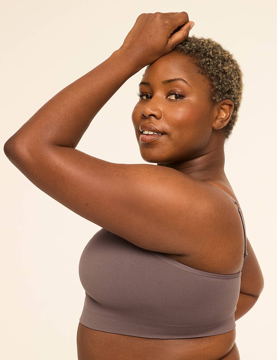 A woman with short, blonde-tipped hair poses with her arm raised against a plain, light background. Product Image 3