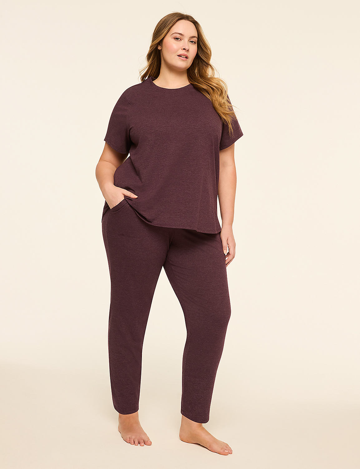 A woman in a burgundy loungewear set stands with her hand in her pocket against a plain, light-colored background. Product Image 1