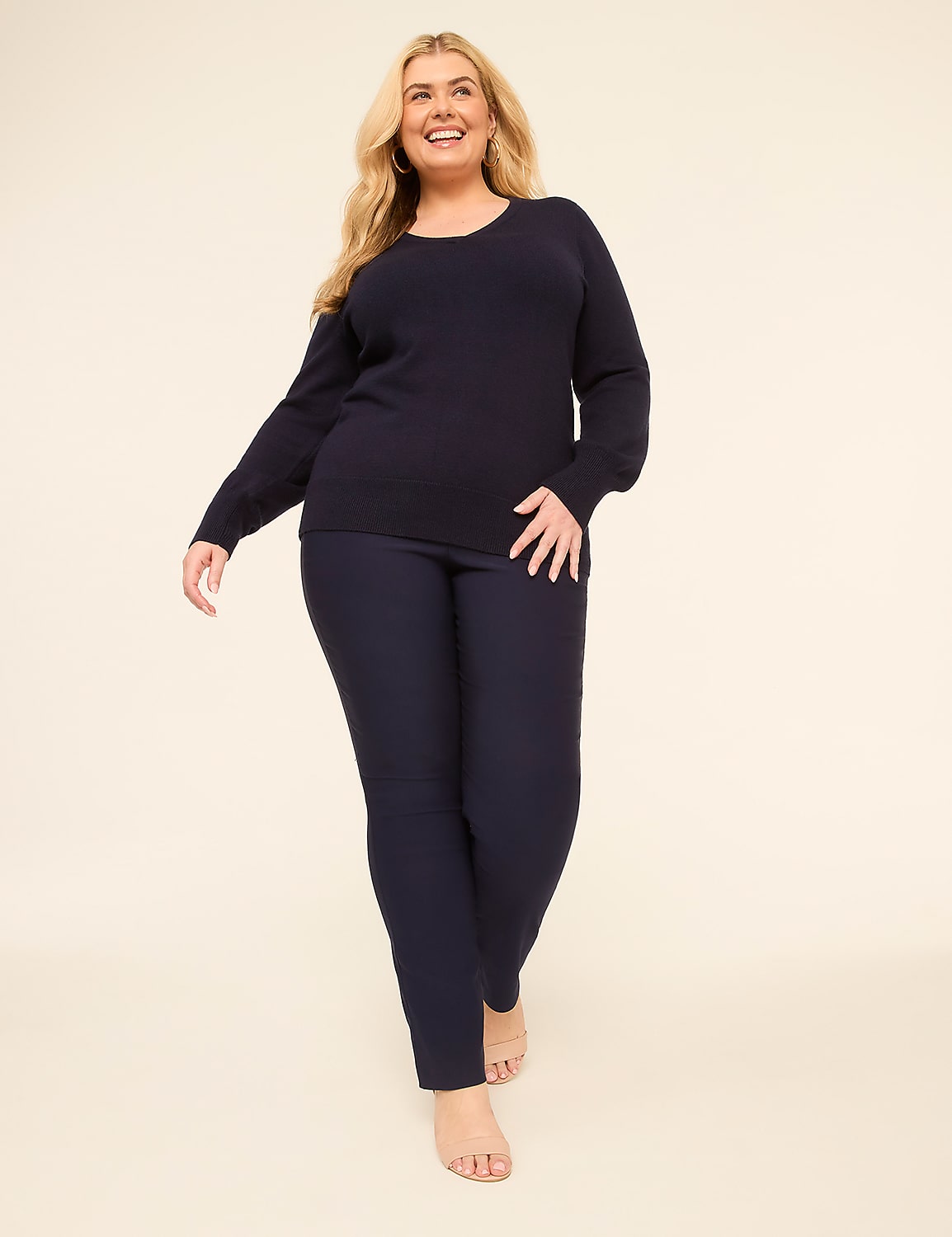 A smiling woman in a navy sweater and pants stands against a plain, light-colored background. Product Image 3