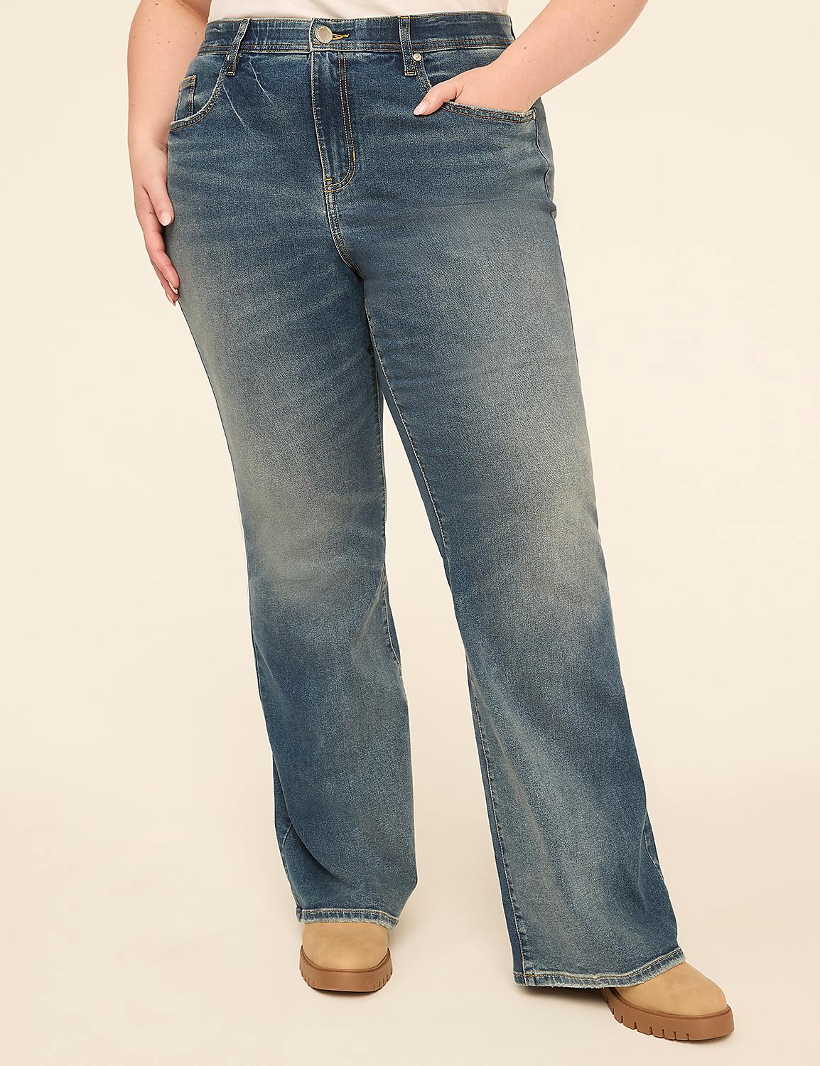 A person wearing flared blue jeans and tan boots stands against a plain, light-colored background. Product Image 1