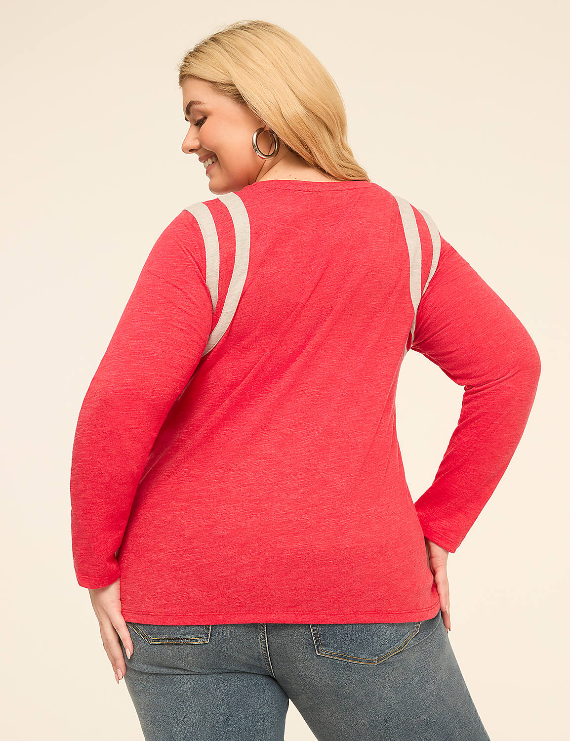 A woman in a red long-sleeved shirt and jeans stands against a plain, light-colored background. Product Image 2