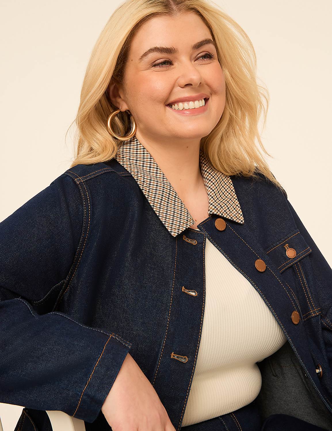 A smiling woman with blonde hair and large hoop earrings wears a denim jacket over a white top, set against a plain, light-colored background. Product Image 5