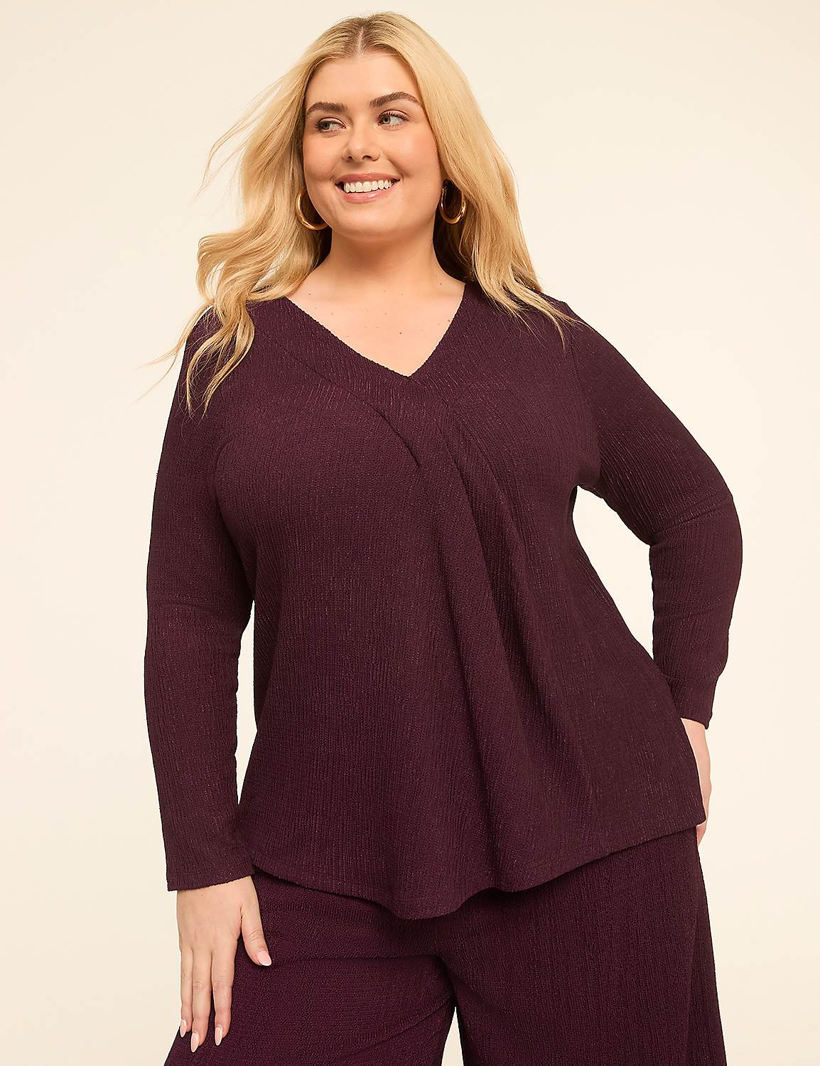 A smiling woman in a plum-colored ribbed top and pants stands against a plain, light-colored background. Product Image 1