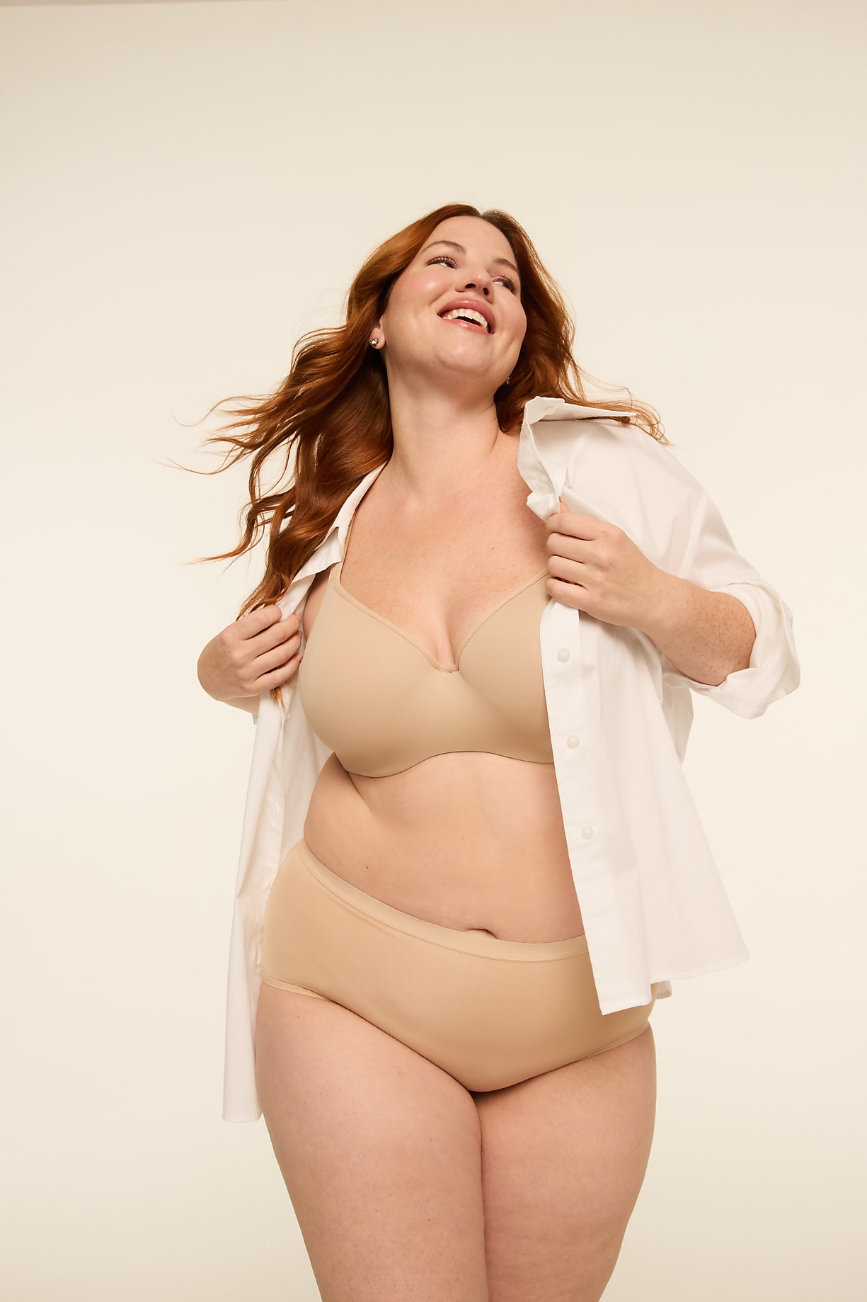 A smiling woman with red hair in a beige bra and underwear stands in front of a plain, light-colored background. Product Image 7