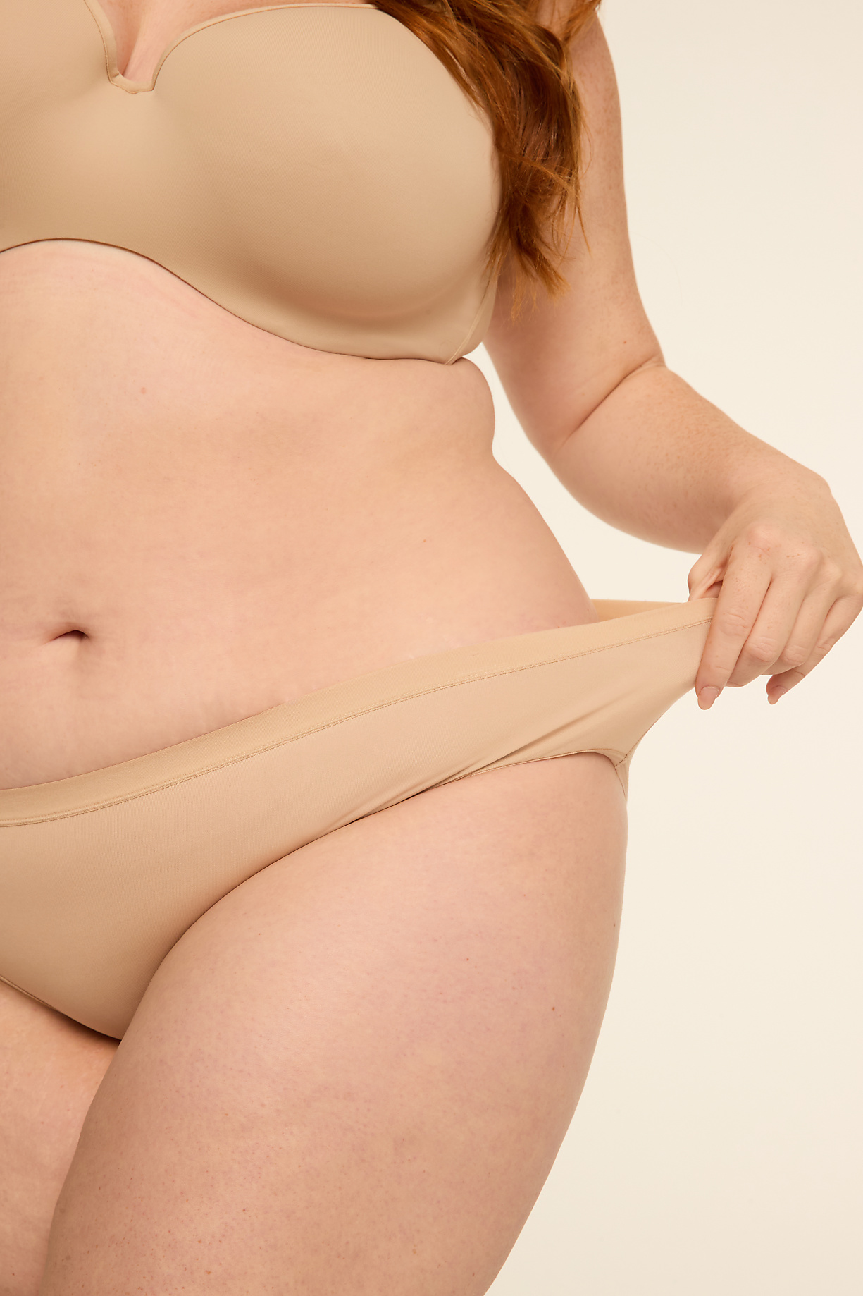 A person's midsection, clad in beige undergarments, is shown against a plain, light background. Product Image 14