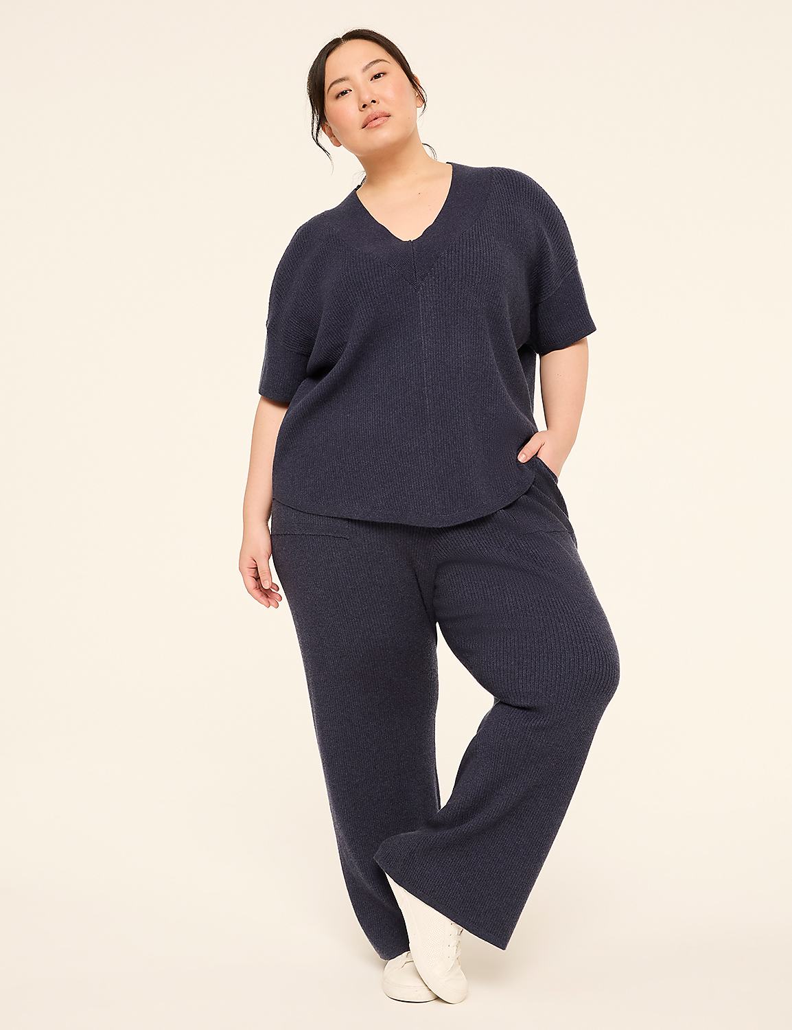 A woman in a navy blue loungewear set stands against a plain, light-colored background. Product Image 3