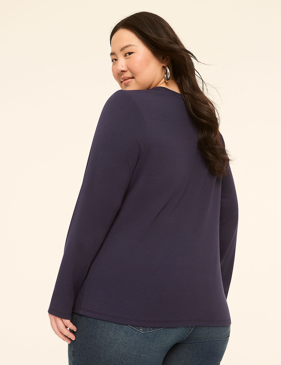 A woman in a navy long-sleeved shirt and jeans poses against a plain, light-colored background. Product Image 2
