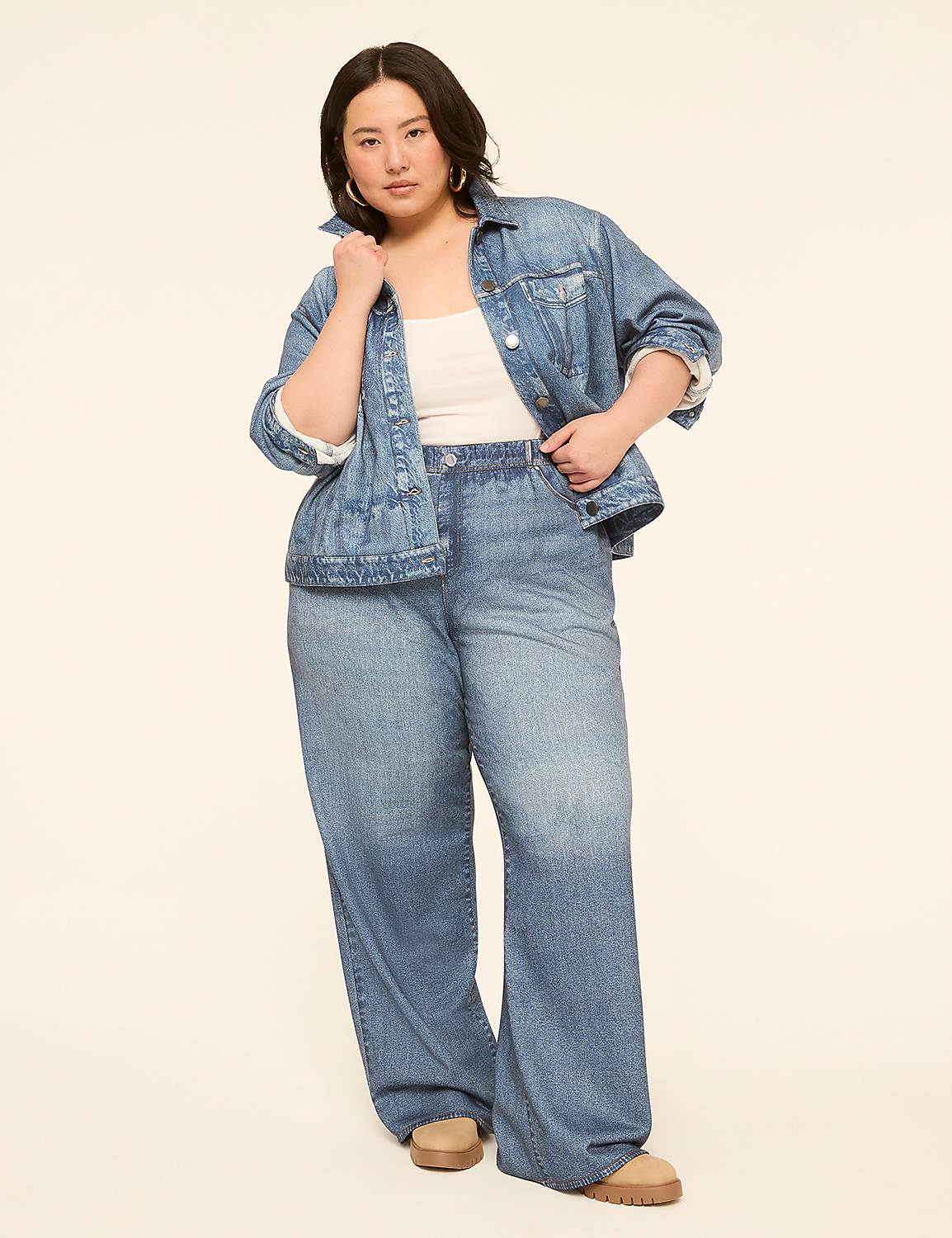 A woman in a denim jacket and wide-leg jeans stands against a plain, light-colored background. Product Image 3