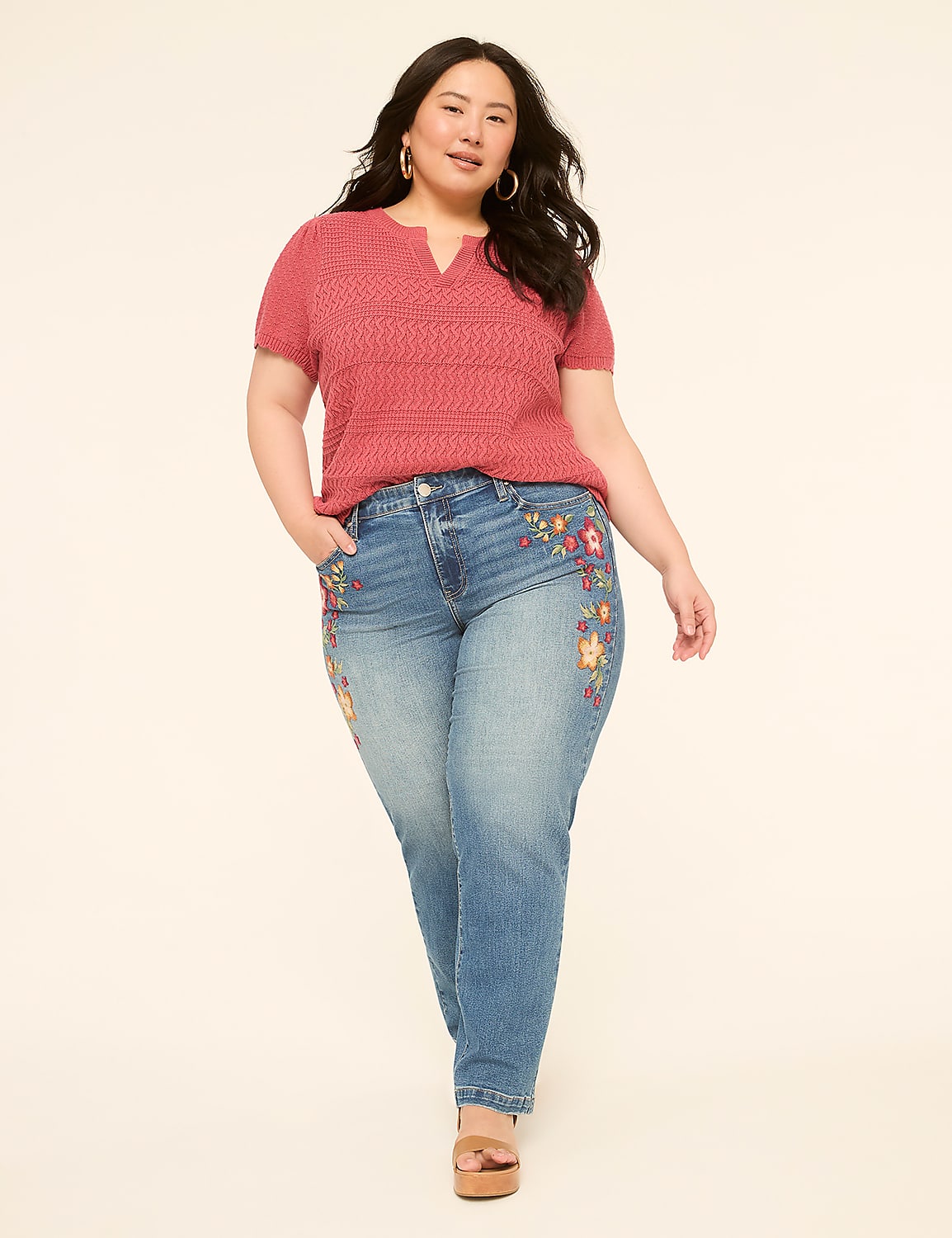 A woman in a pink top and embroidered jeans stands against a plain, light-colored background. Product Image 3