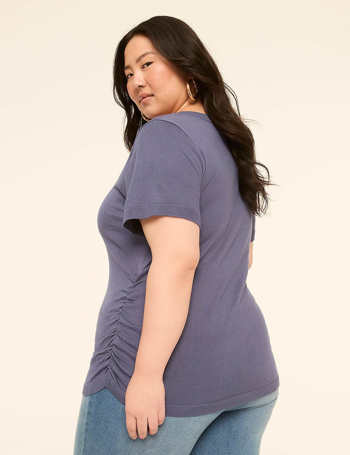 A woman in a blue t-shirt and jeans stands against a plain, light-colored background. Product Image 2