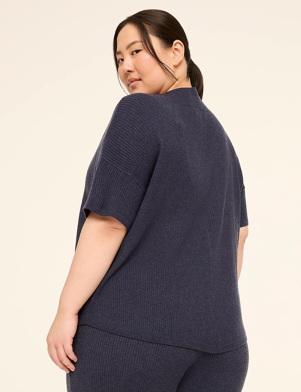 A woman in a navy blue ribbed sweater and pants poses against a plain, light-colored background. Product Image 2