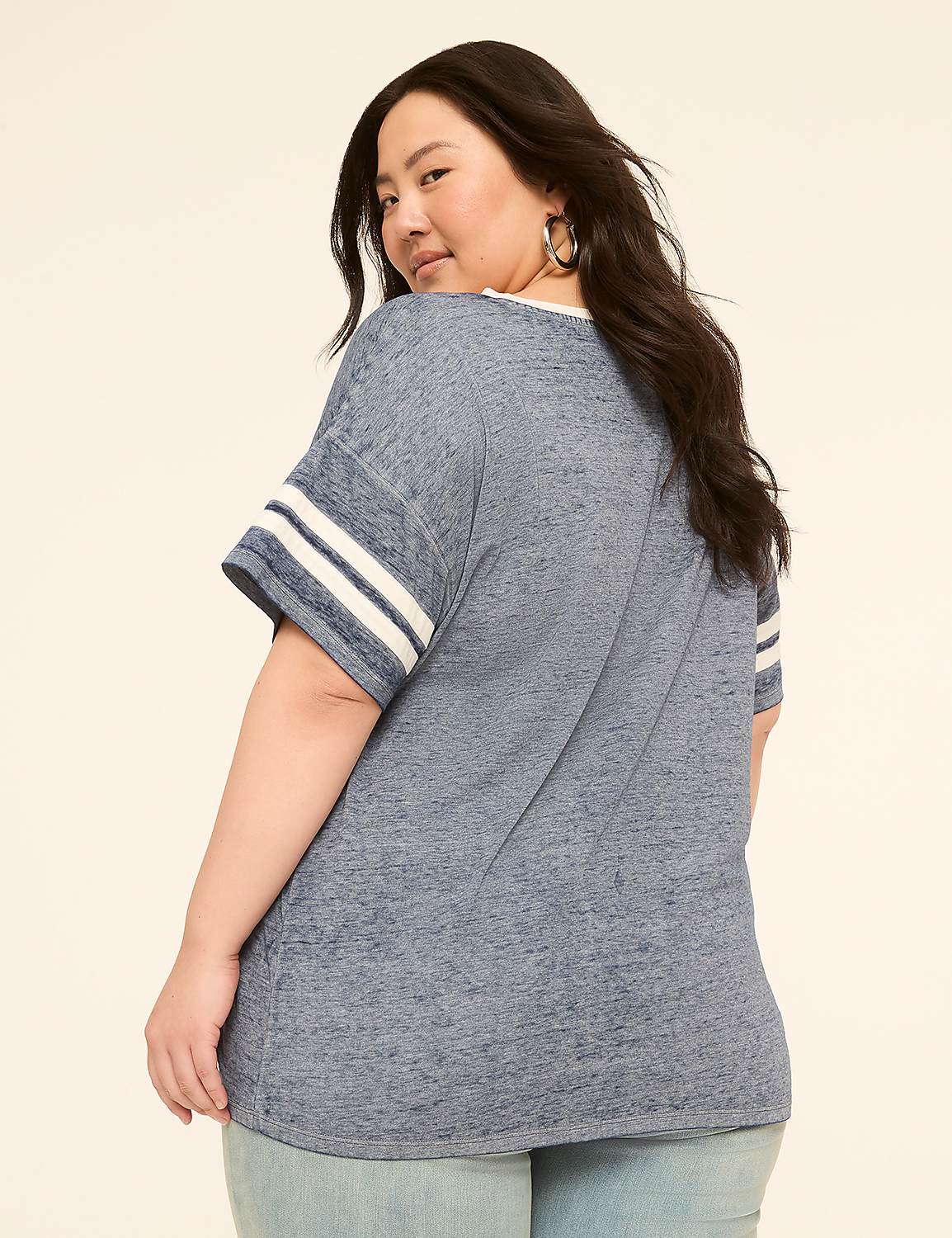 A woman in a blue t-shirt and jeans poses against a plain, light-colored background. Product Image 2