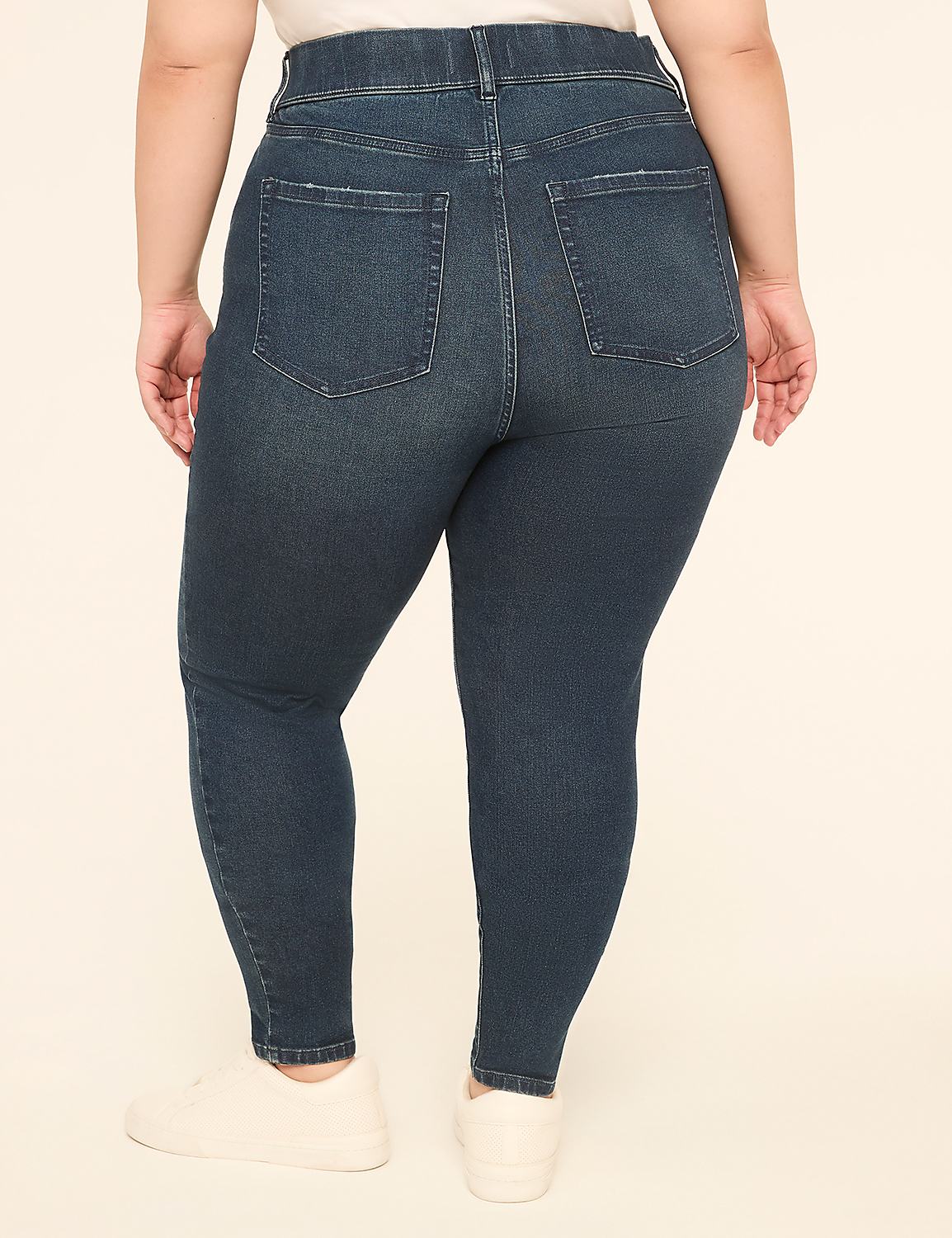 A person wearing dark wash skinny jeans and white sneakers stands against a plain, light-colored background. Product Image 2