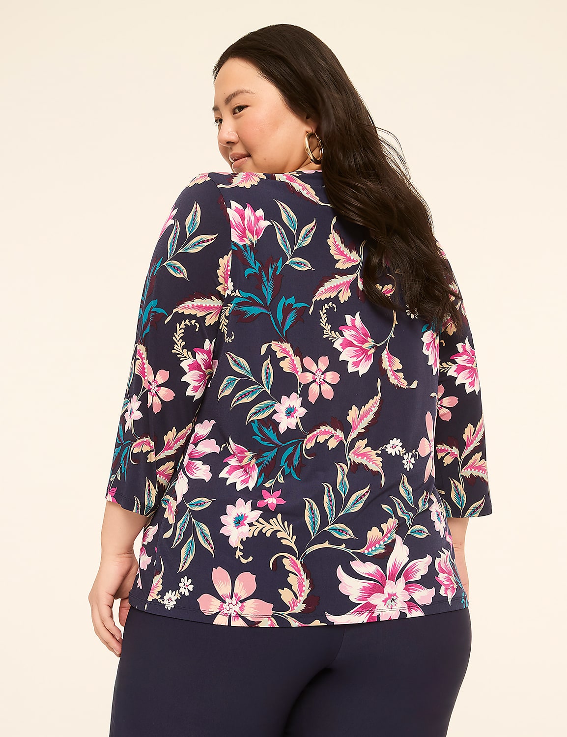 A woman with dark hair, wearing a navy blue floral-patterned top and navy blue pants, is shown from the back against a plain, light-colored background. Product Image 2