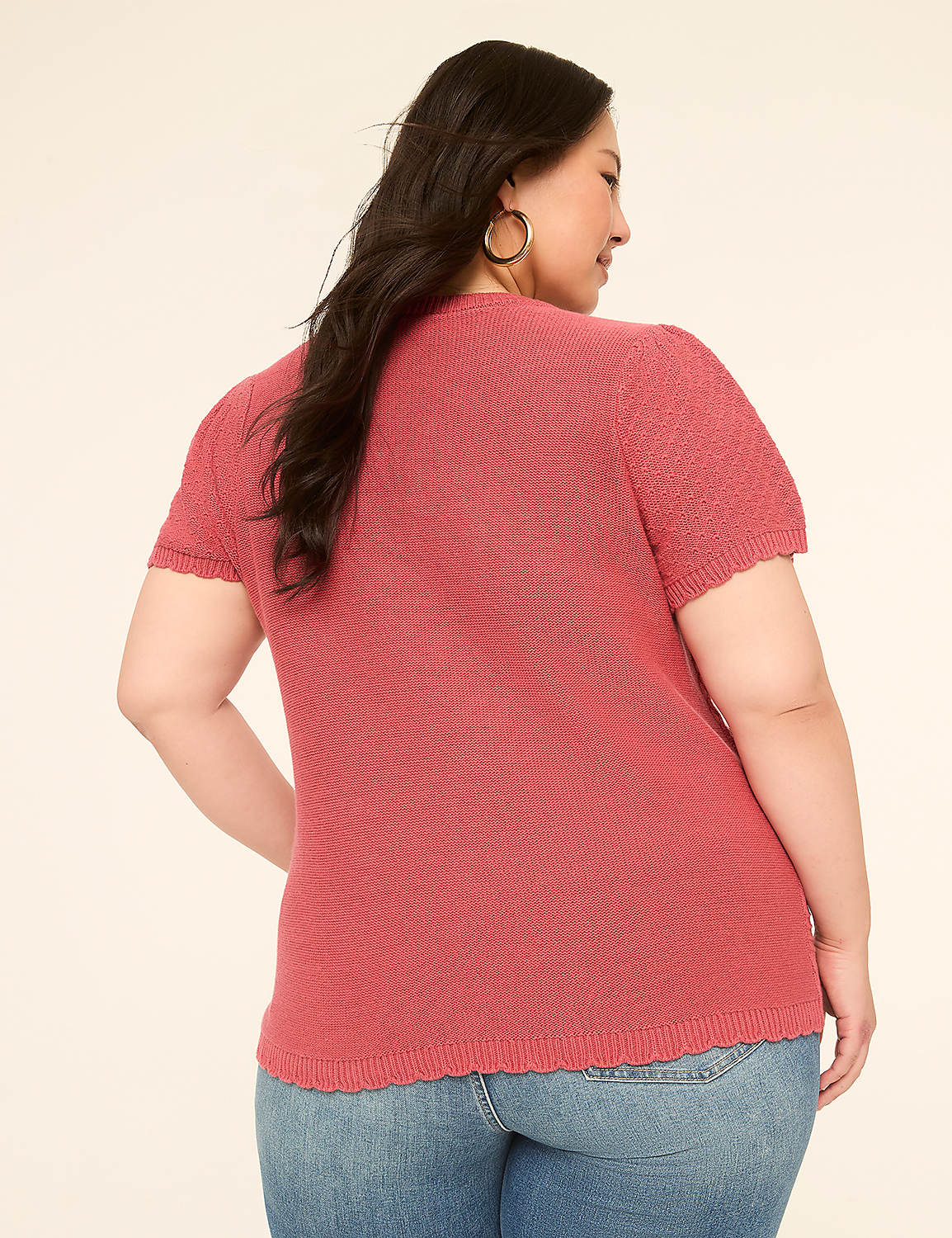 A woman in a pink top and jeans stands against a plain, light-colored background. Product Image 2