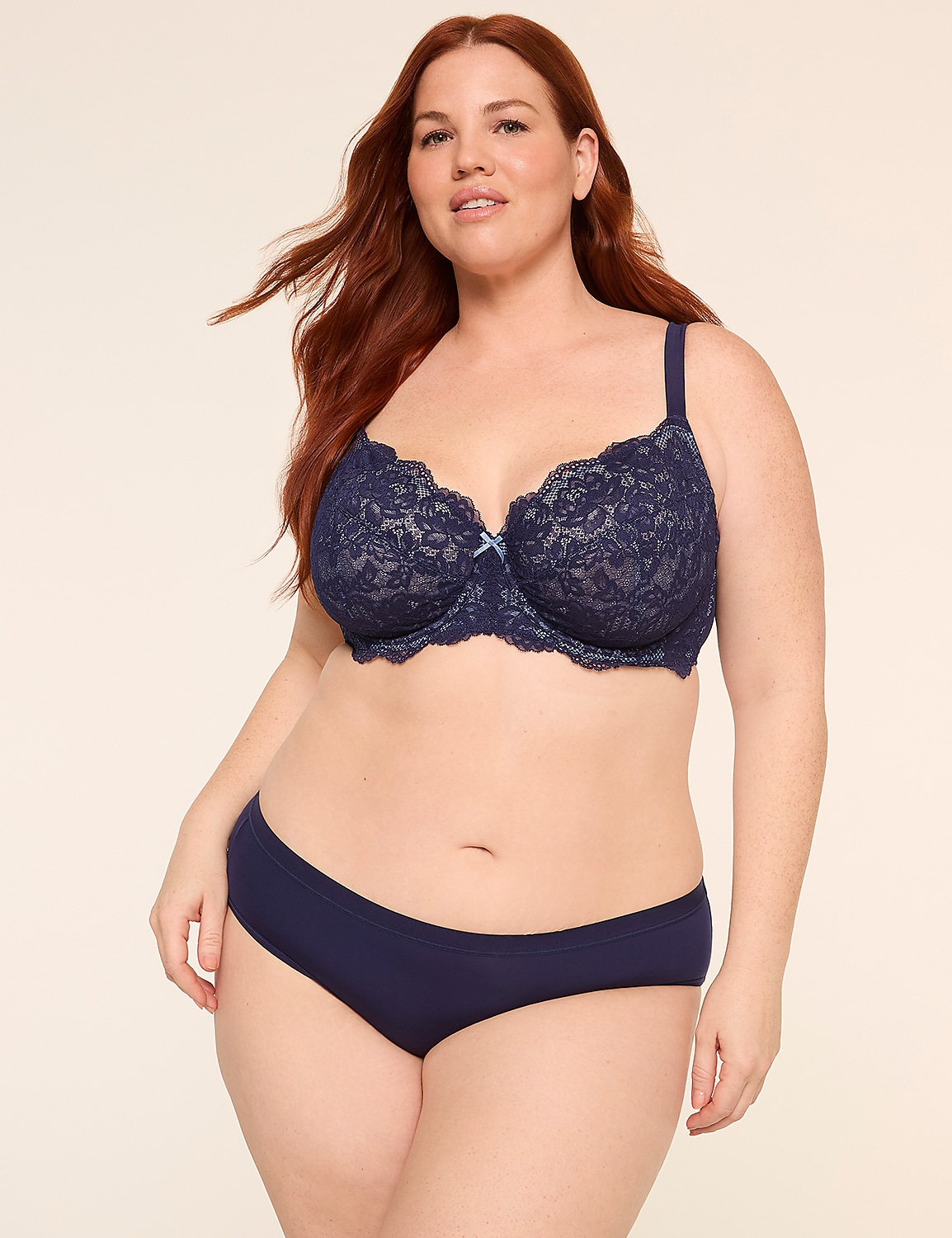 A woman with red hair poses in navy blue lace lingerie against a plain, light-colored background. Product Image 3