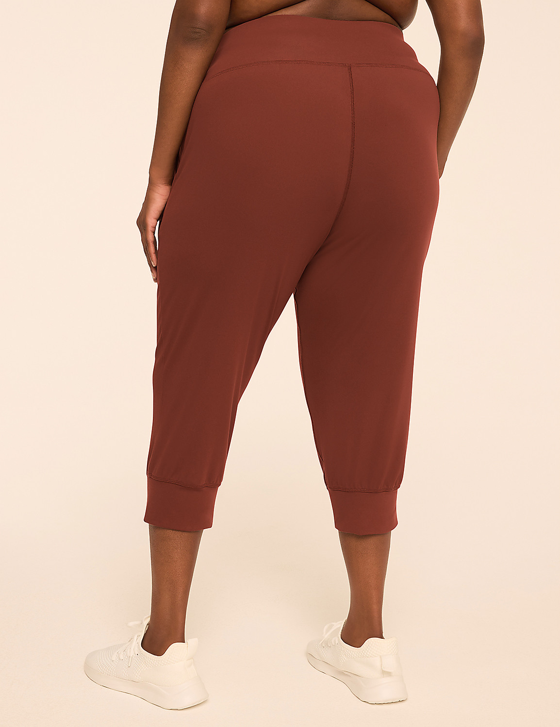 A person wearing rust-colored cropped pants and white sneakers stands against a plain beige background. Product Image 2