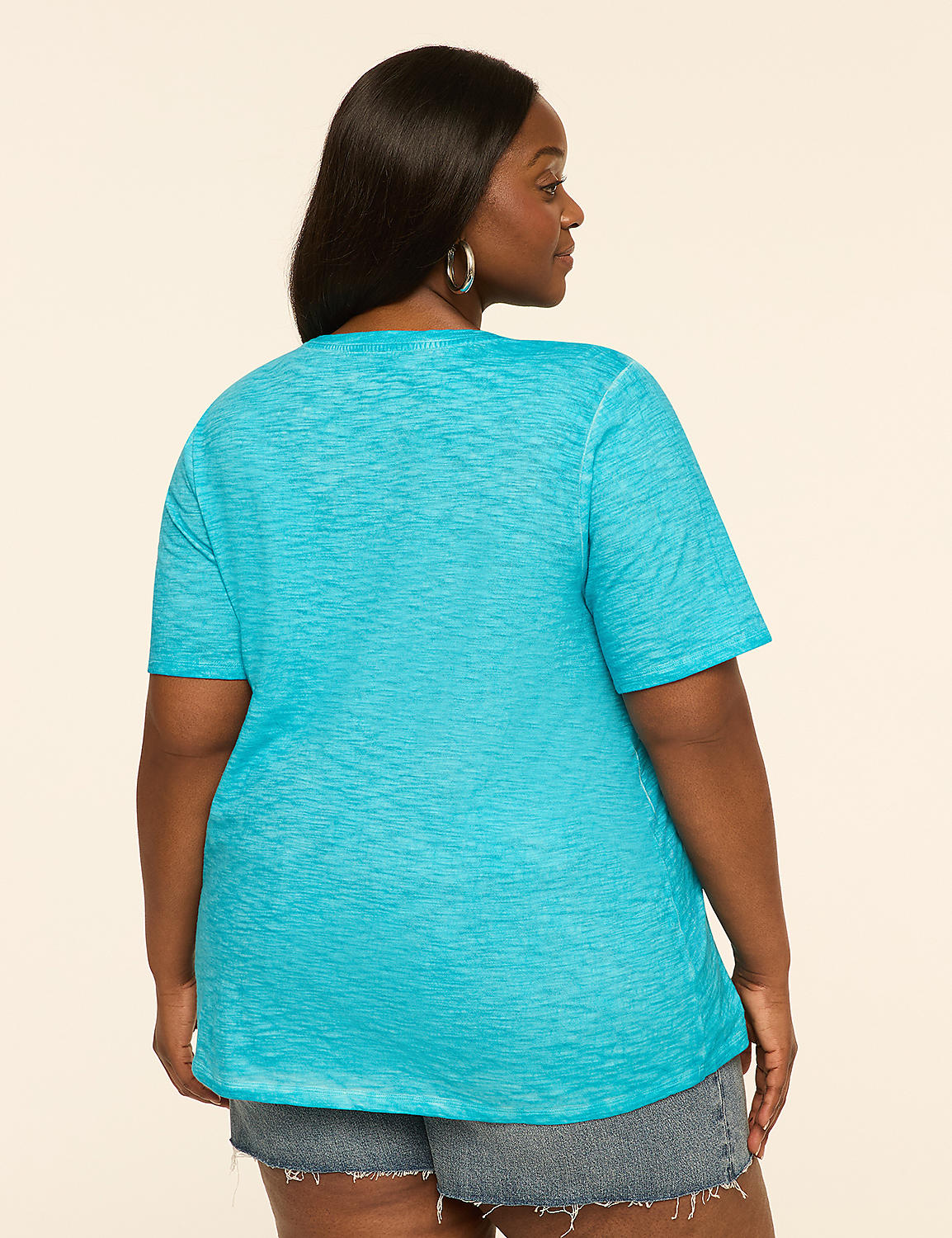 A woman in a turquoise t-shirt and denim shorts stands against a plain, light-colored background. Product Image 2
