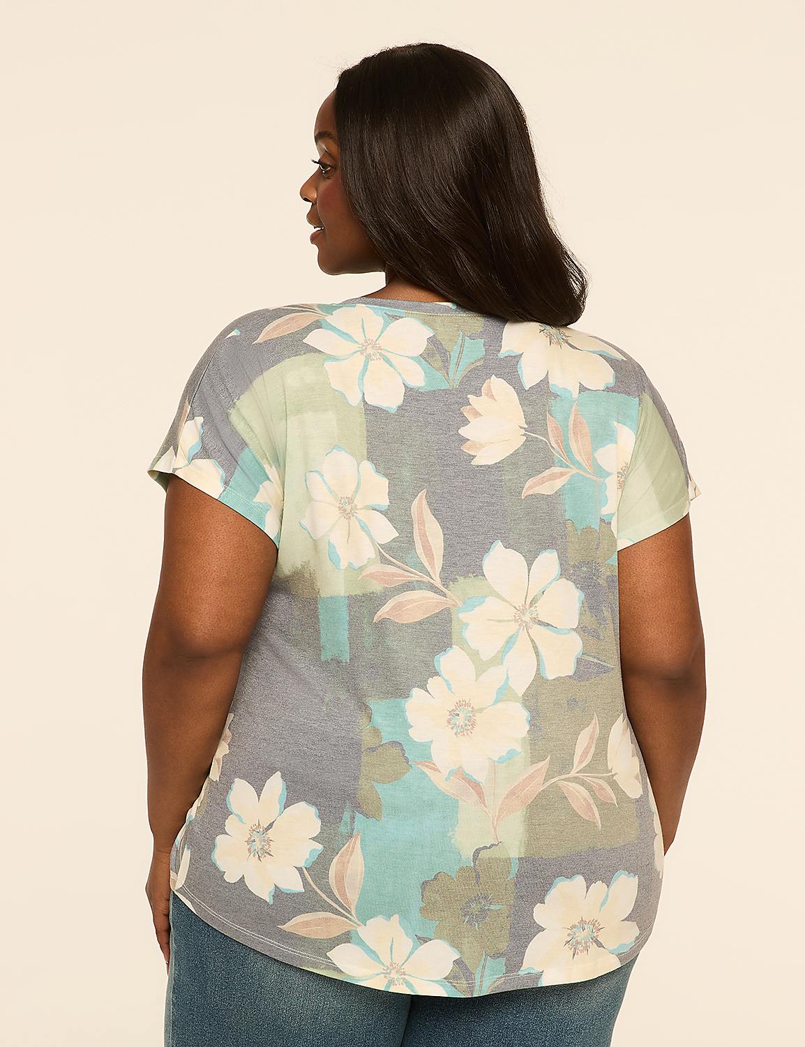 A woman wearing a floral print top stands against a plain, light-colored background. Product Image 2