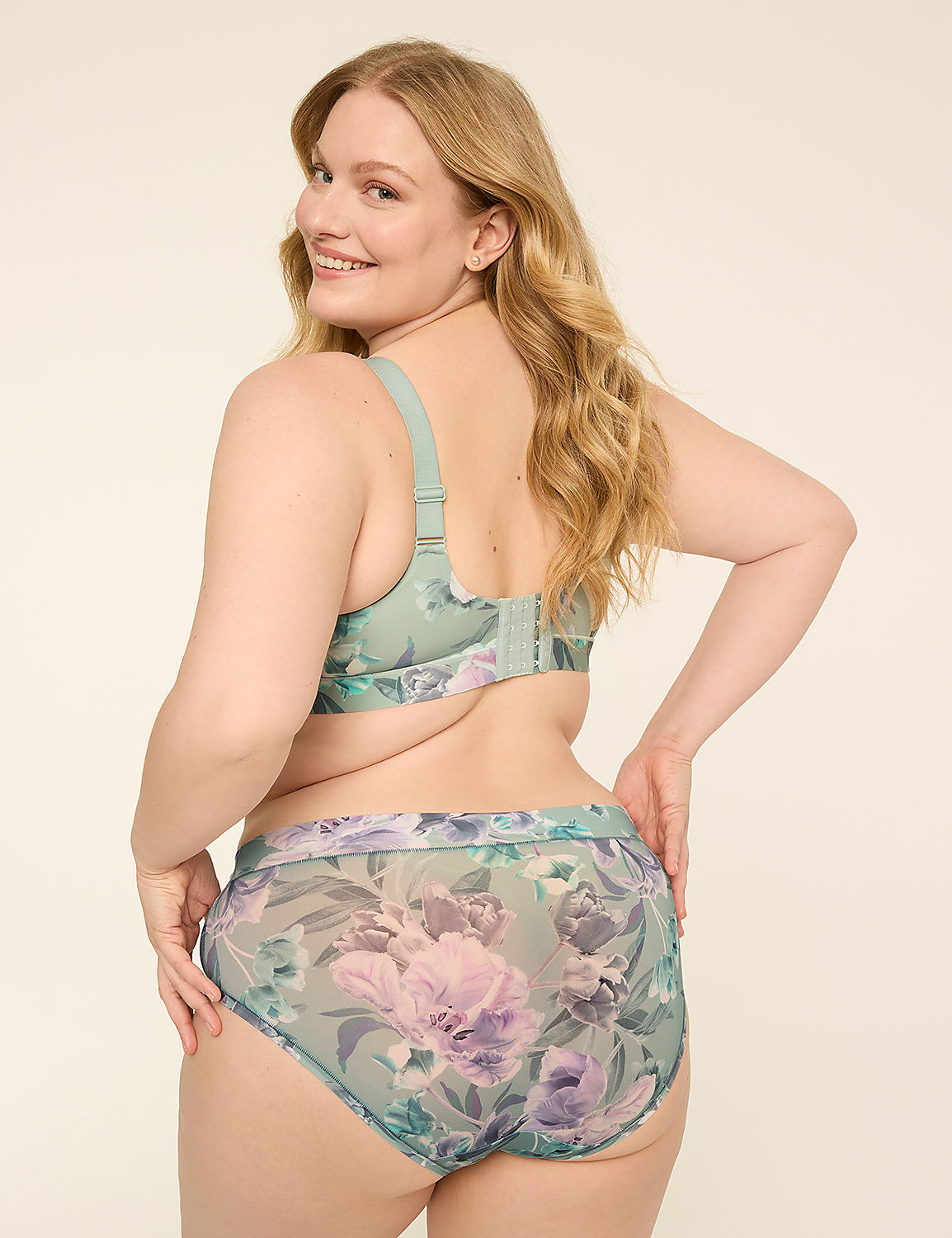 A woman in floral lingerie smiles over her shoulder against a plain, light background. Product Image 2