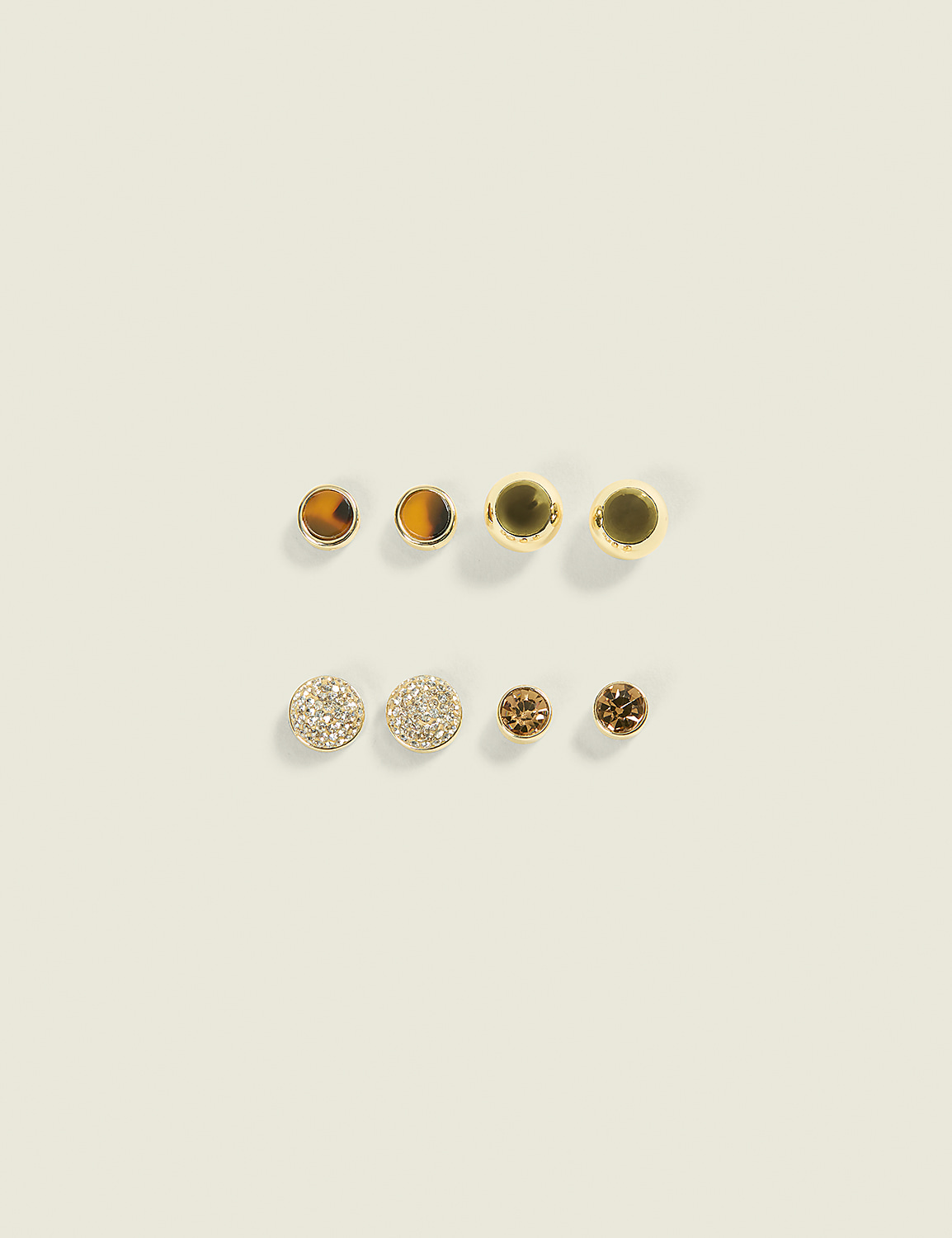 Four pairs of earrings, featuring a mix of gold, tiger's eye, and crystal designs, are arranged on a plain, light-colored background. Product Image 1