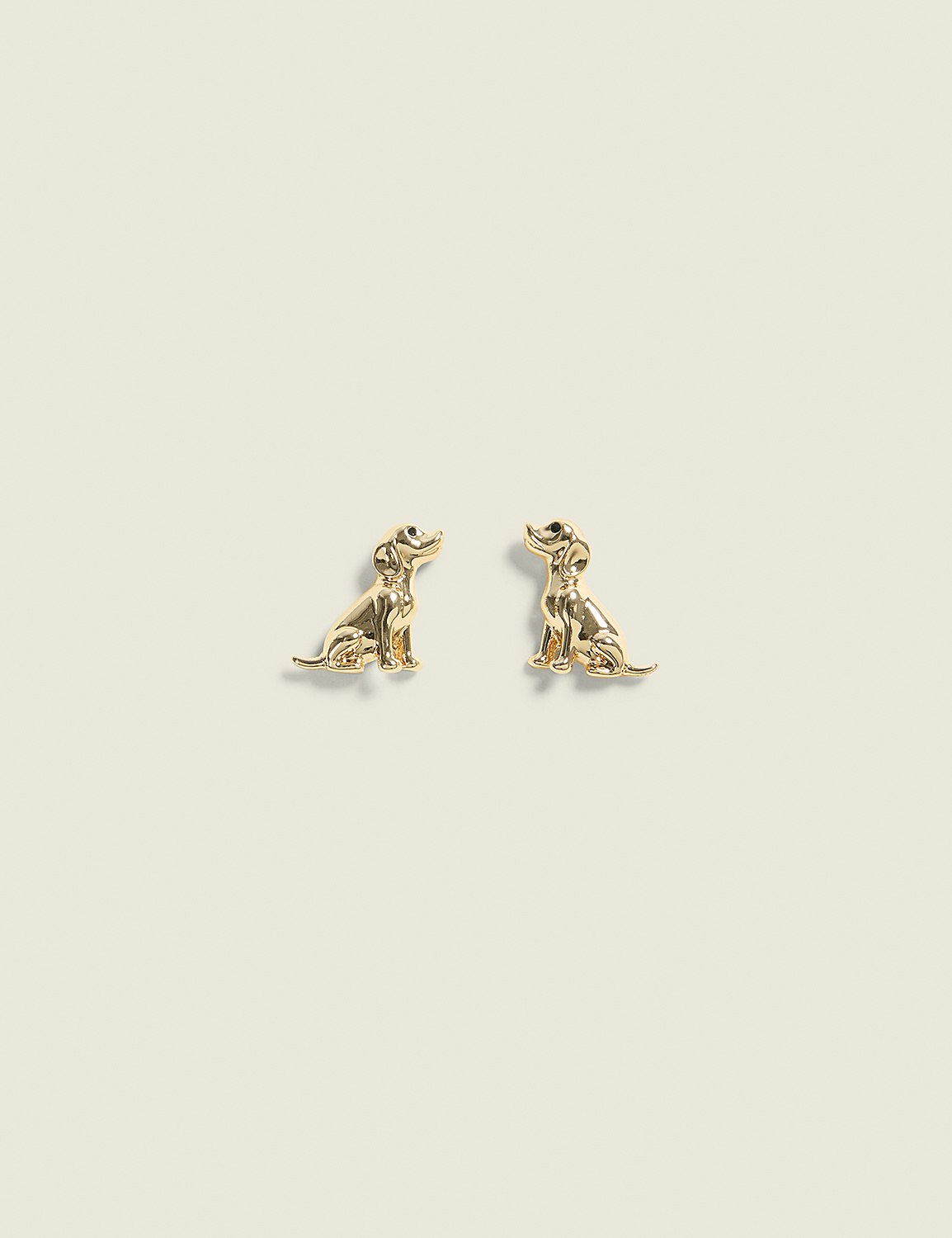 Two golden dog-shaped earrings sit on a plain, light-colored background. Product Image 1