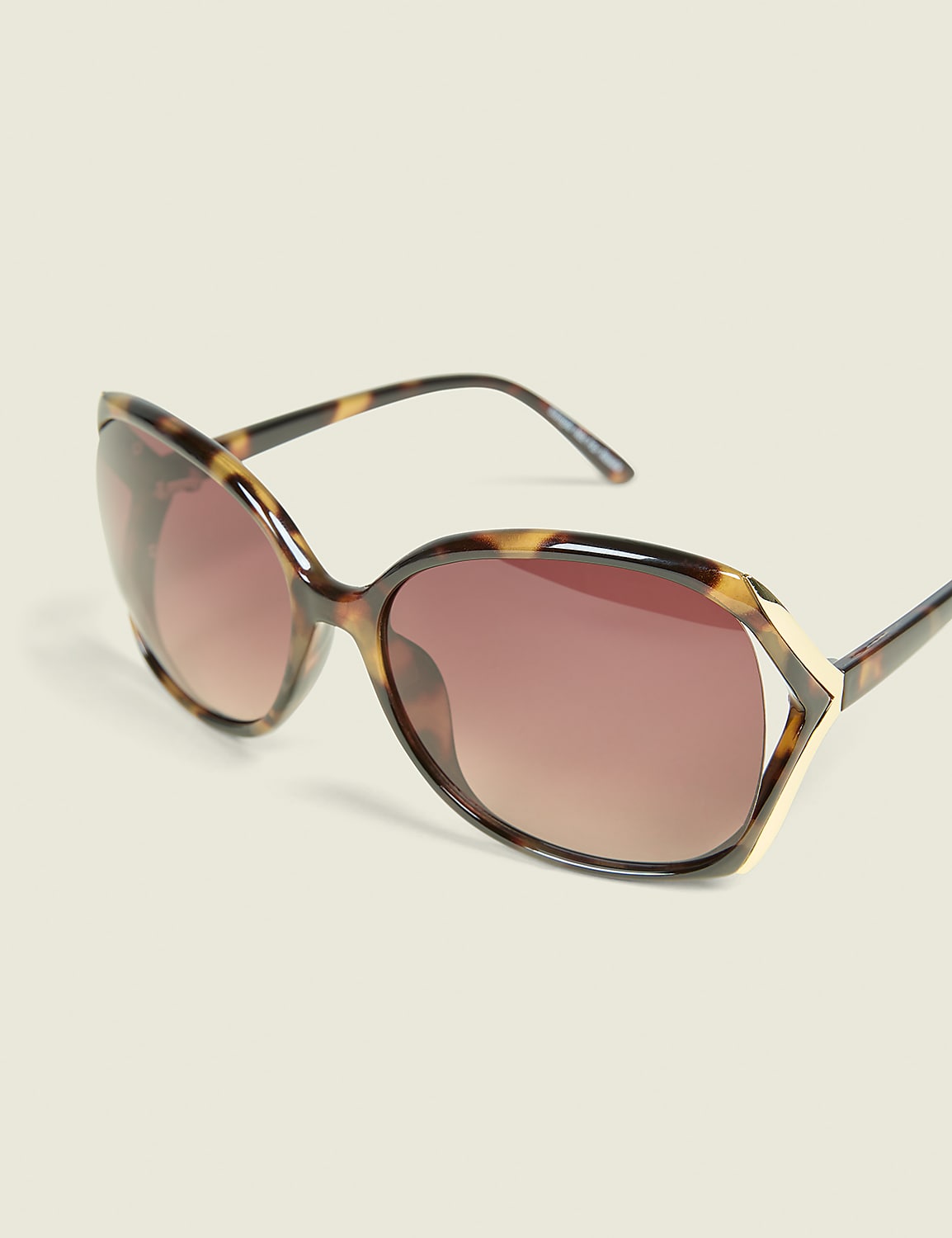 Tortoiseshell oversized sunglasses with gradient lenses are displayed against a plain, light-colored background. Product Image 1