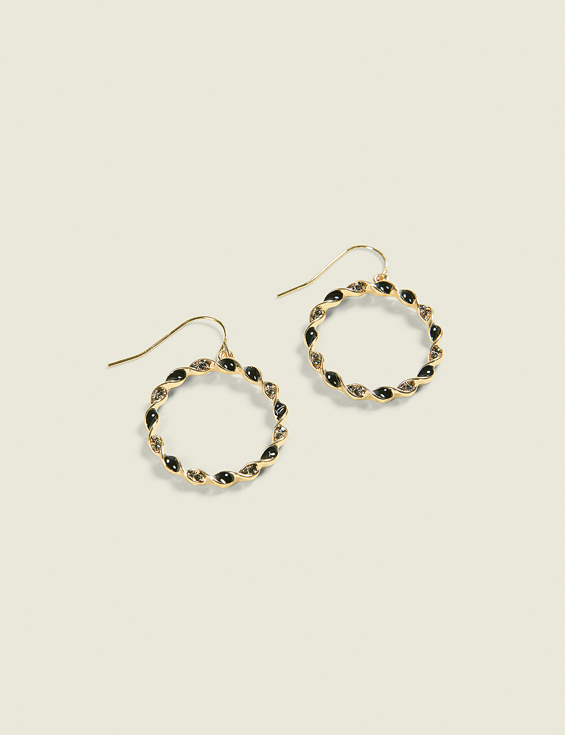 A pair of gold hoop earrings with black stones are displayed against a plain, light-colored background. Product Image 1