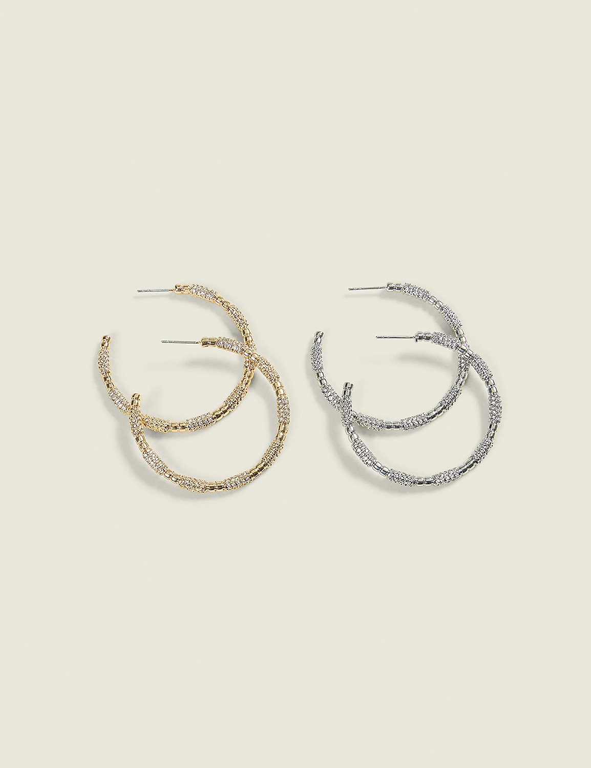 Two pairs of textured hoop earrings, one gold and one silver, are displayed against a plain, light-colored background. Product Image 1