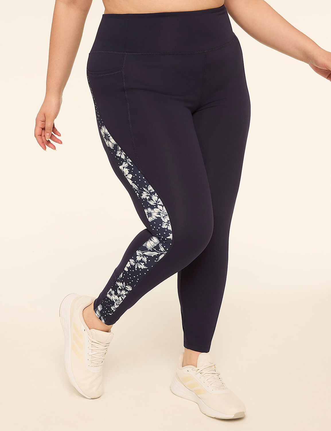 A person in navy leggings with a tie-dye stripe down the side stands against a plain, light-colored background. Product Image 1