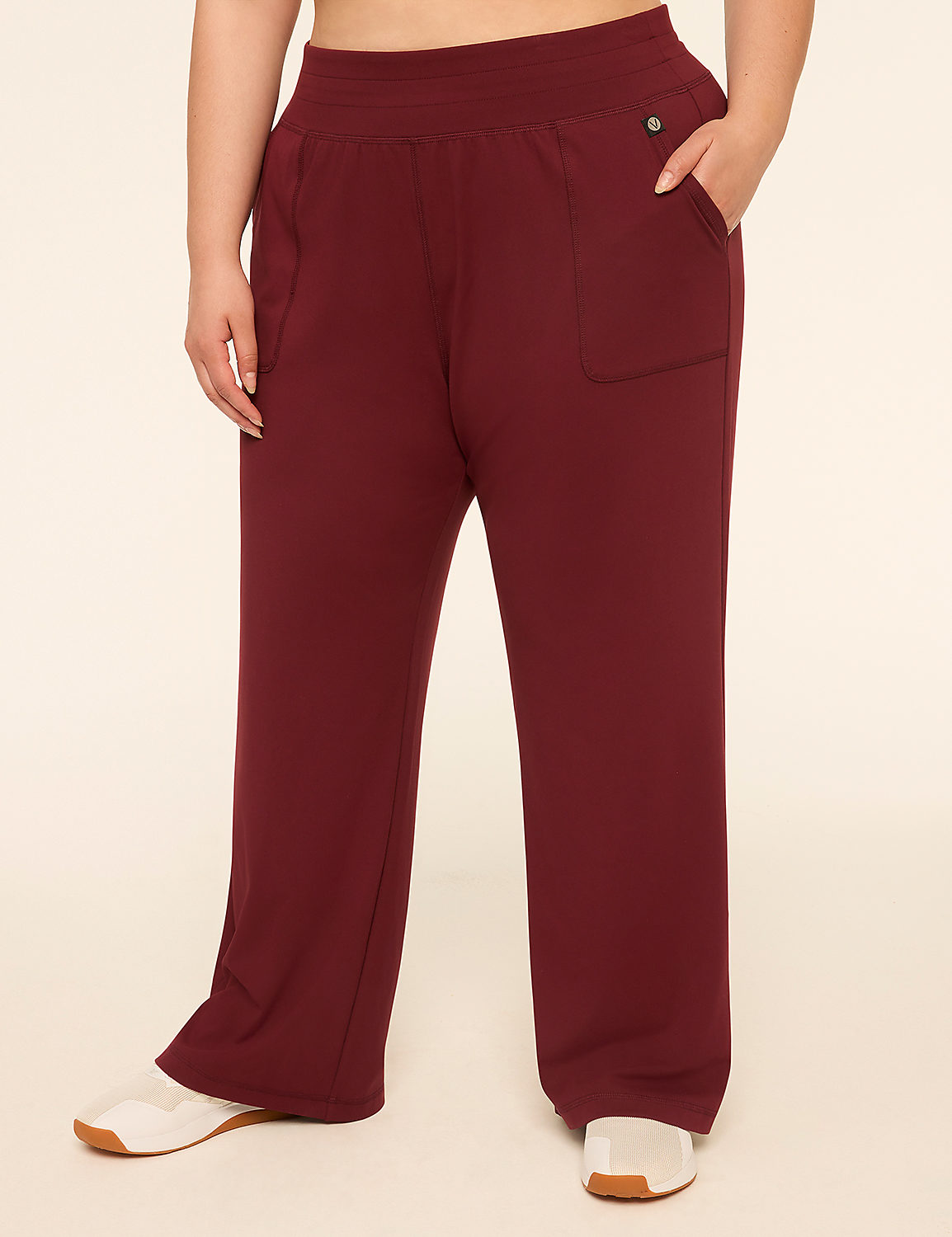 A person wearing maroon sweatpants with white sneakers stands against a plain beige background. Product Image 1