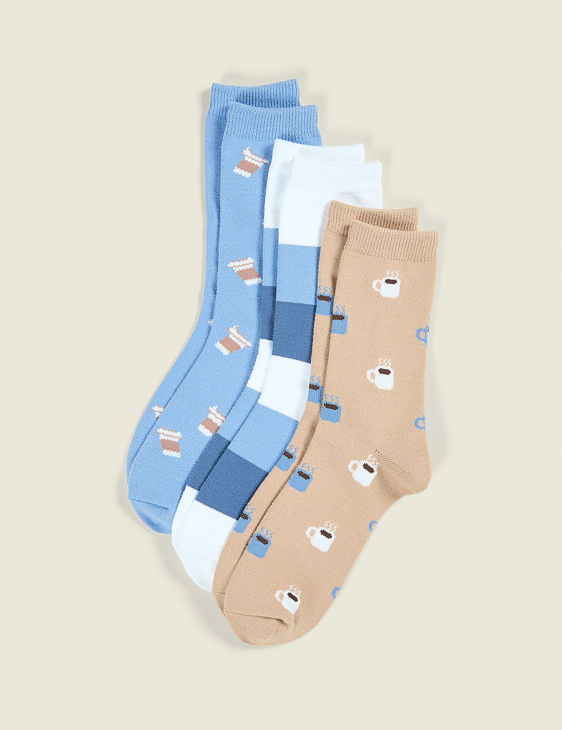Three pairs of socks with coffee cup patterns are arranged in the foreground against a plain, light-colored background. Product Image 1