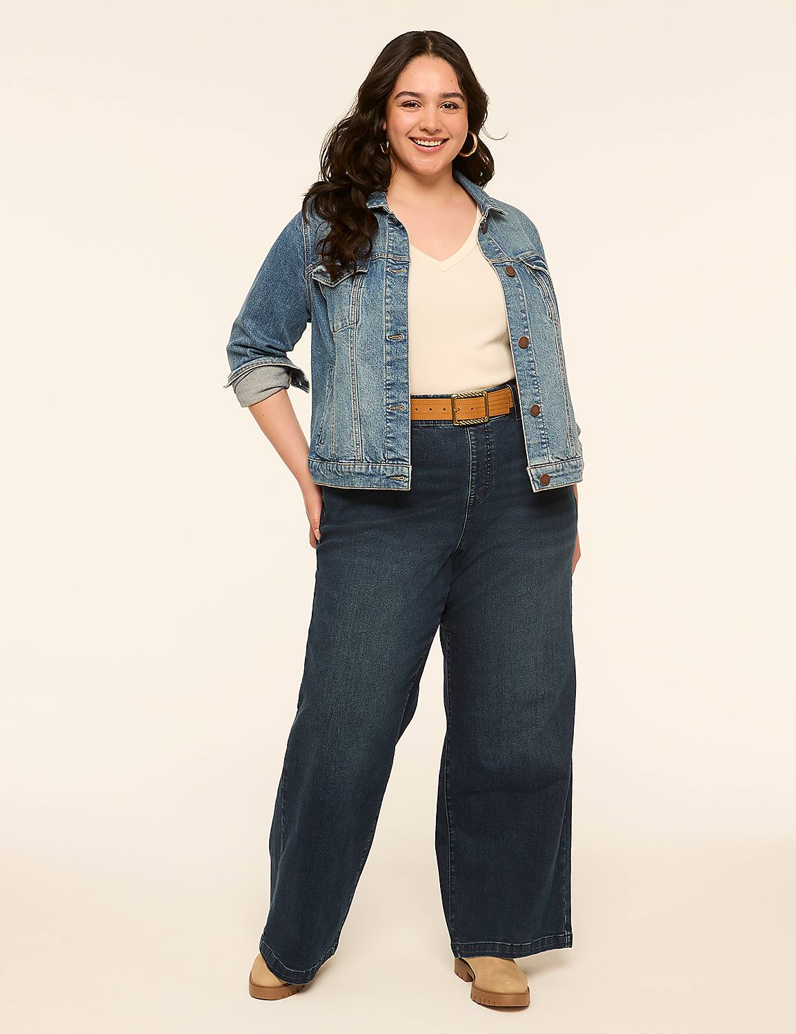 A smiling woman in a denim jacket and wide-leg jeans stands against a plain, light-colored background. Product Image 3