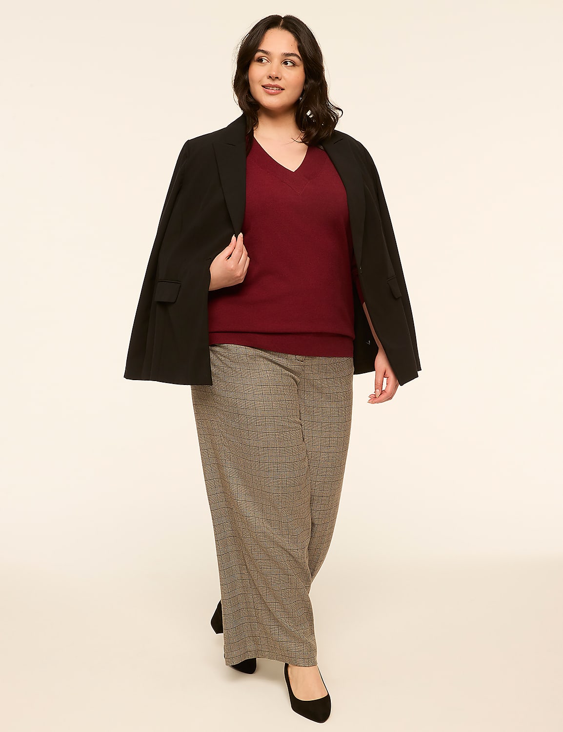 A woman in a burgundy sweater, black blazer, and plaid pants stands against a plain, light-colored background. Product Image 3