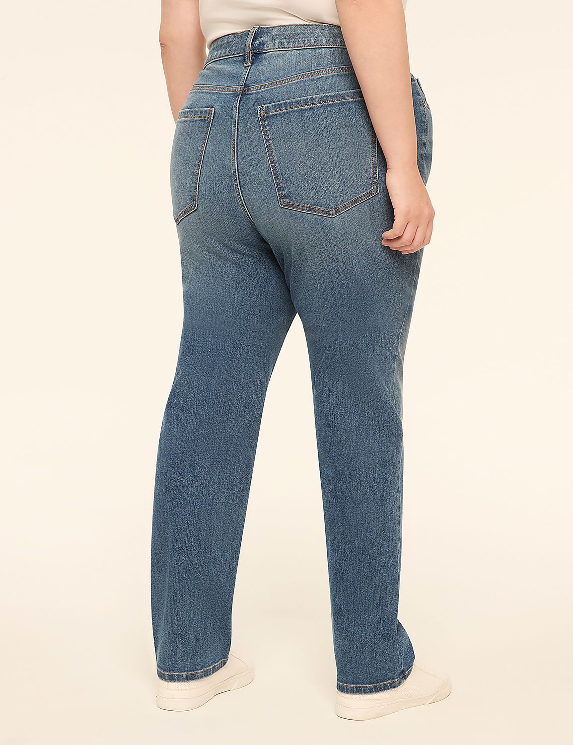 A person wearing blue jeans and white sneakers stands against a plain, light-colored background. Product Image 2