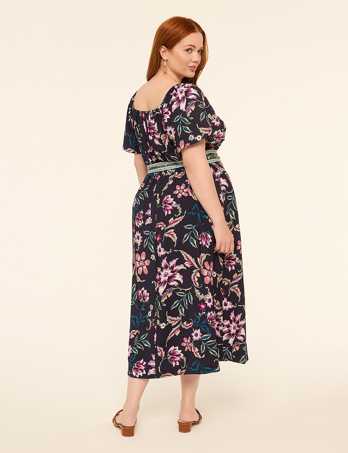 A woman with red hair wearing a floral dress stands against a plain, light-colored background. Product Image 2