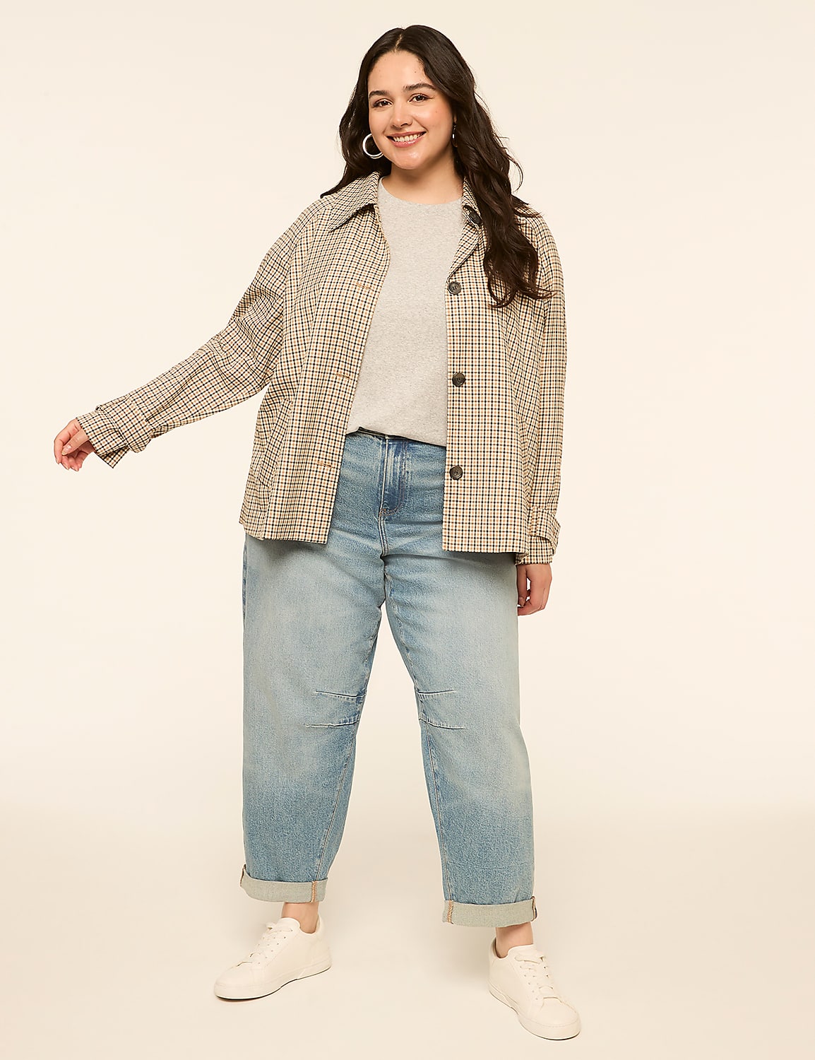 A smiling woman in a plaid jacket and jeans stands against a plain, light-colored background. Product Image 3