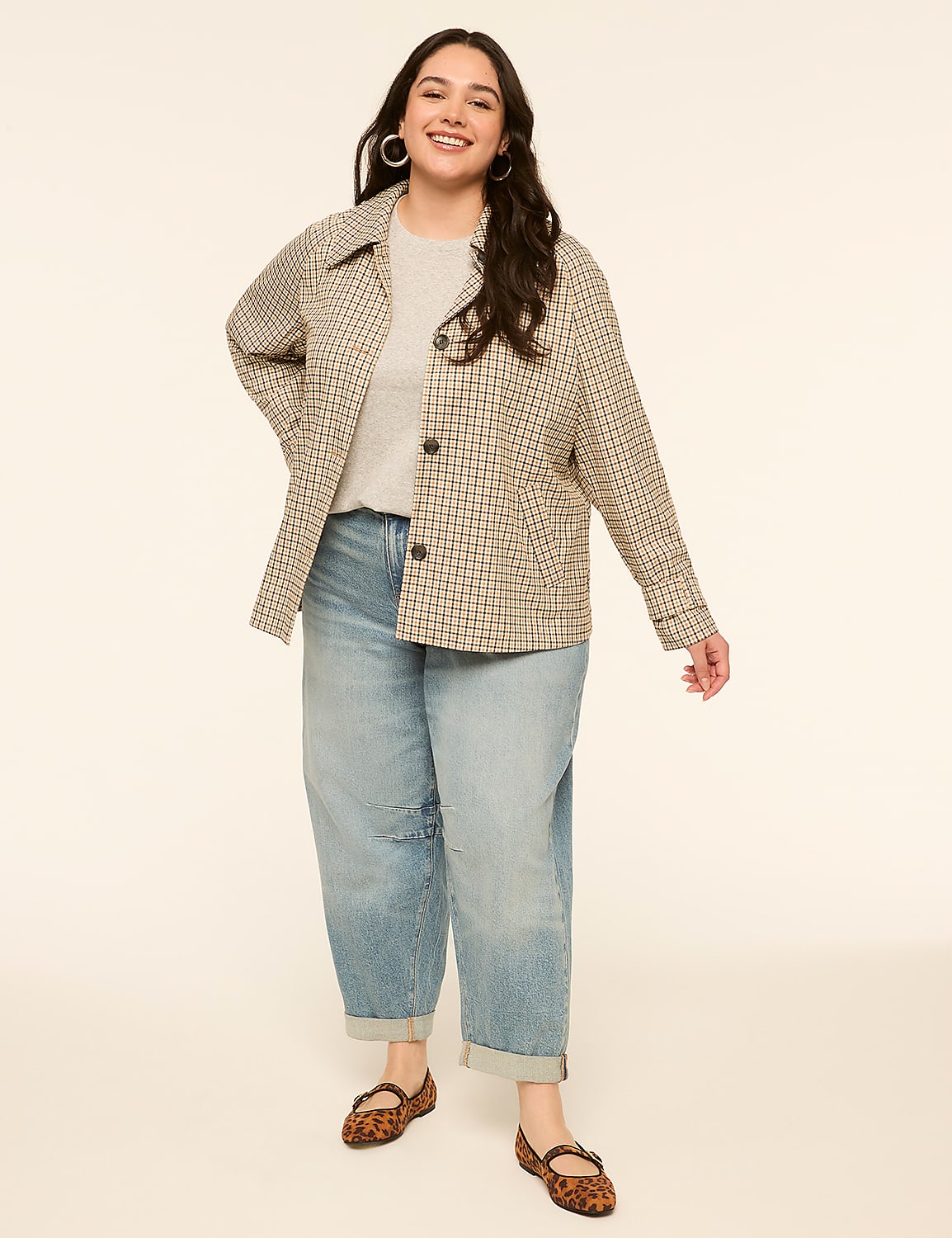 A smiling woman in a patterned jacket and light wash jeans stands against a plain, light-colored background. Product Image 3